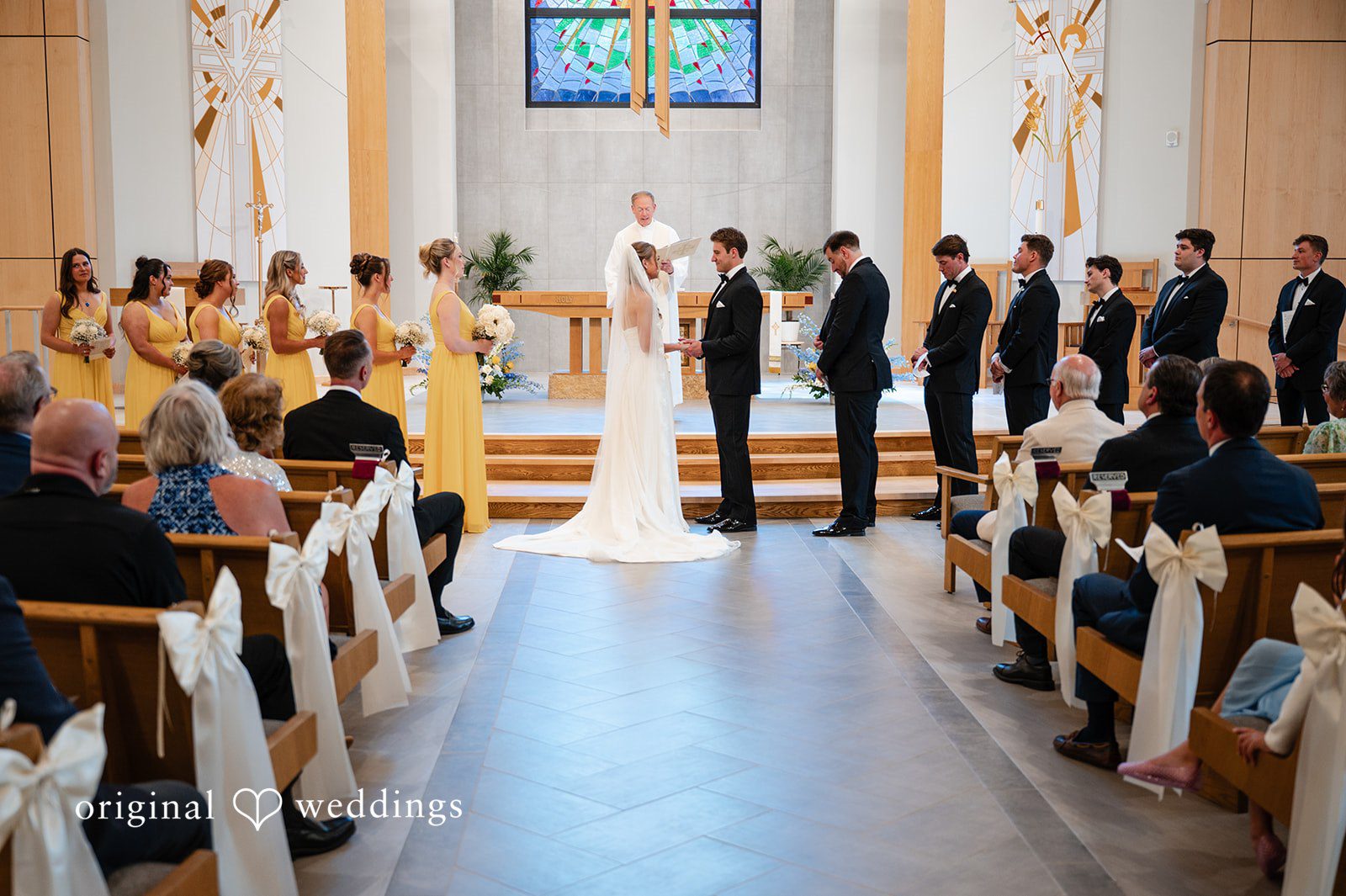 Brandi + Ryan Couple looking at each other with smiles at Christ the Lord Lutheran Church captured by Milwaukee Wedding Photographers from Original Weddings