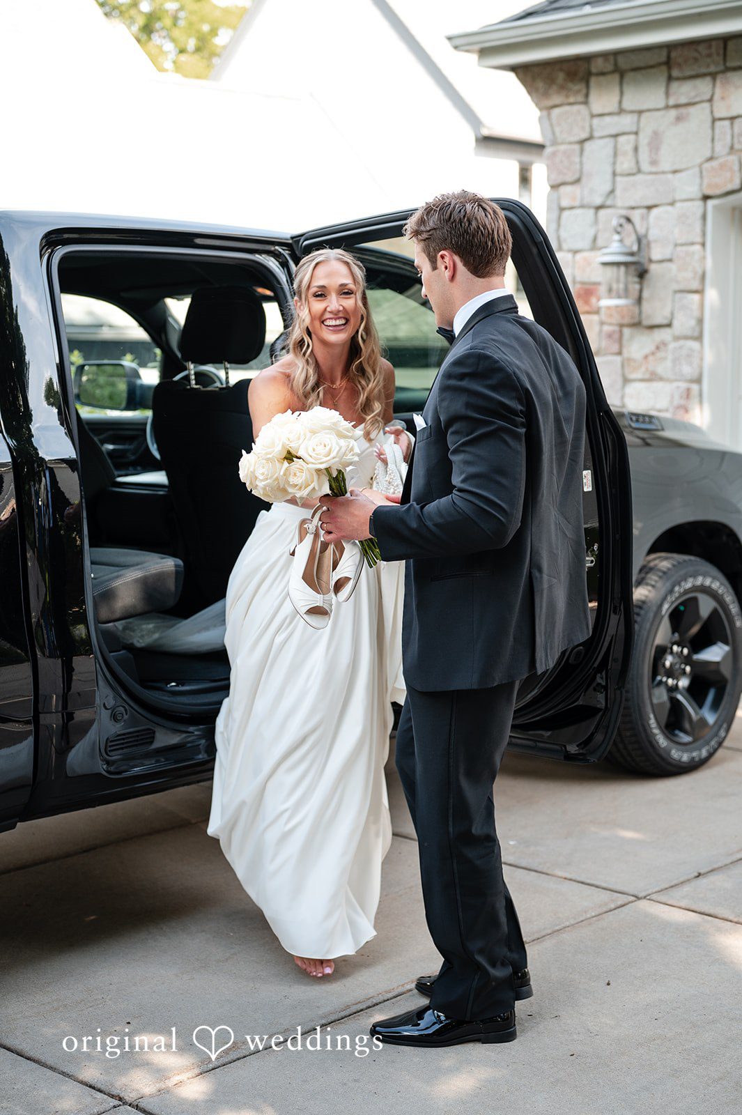 Brandi + Ryan Bride stepping out of a wedding car at Christ the Lord Lutheran Church captured by Milwaukee Wedding Photographers from Original Weddings