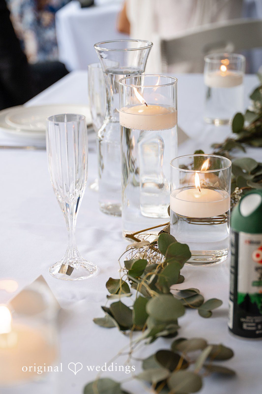 Brandi + Ryan Beautifully decorated reception table with candles prepared for wedding guests.