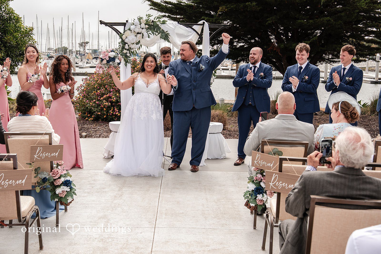 Thuy + Ryan Bride and groom celebrating after ceremony at Double Tree by Hilton Hotel Berkeley captured by San Francisco Wedding Photographers from Original Weddings