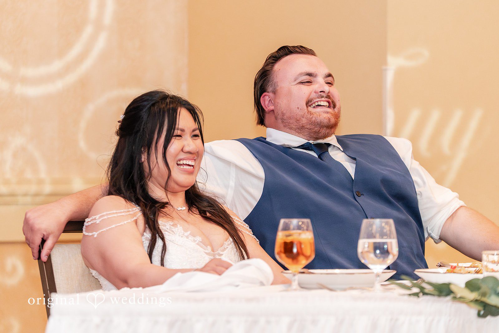 Thuy + Ryan Bride and groom laughing together during the wedding reception at Double Tree by Hilton Hotel Berkeley