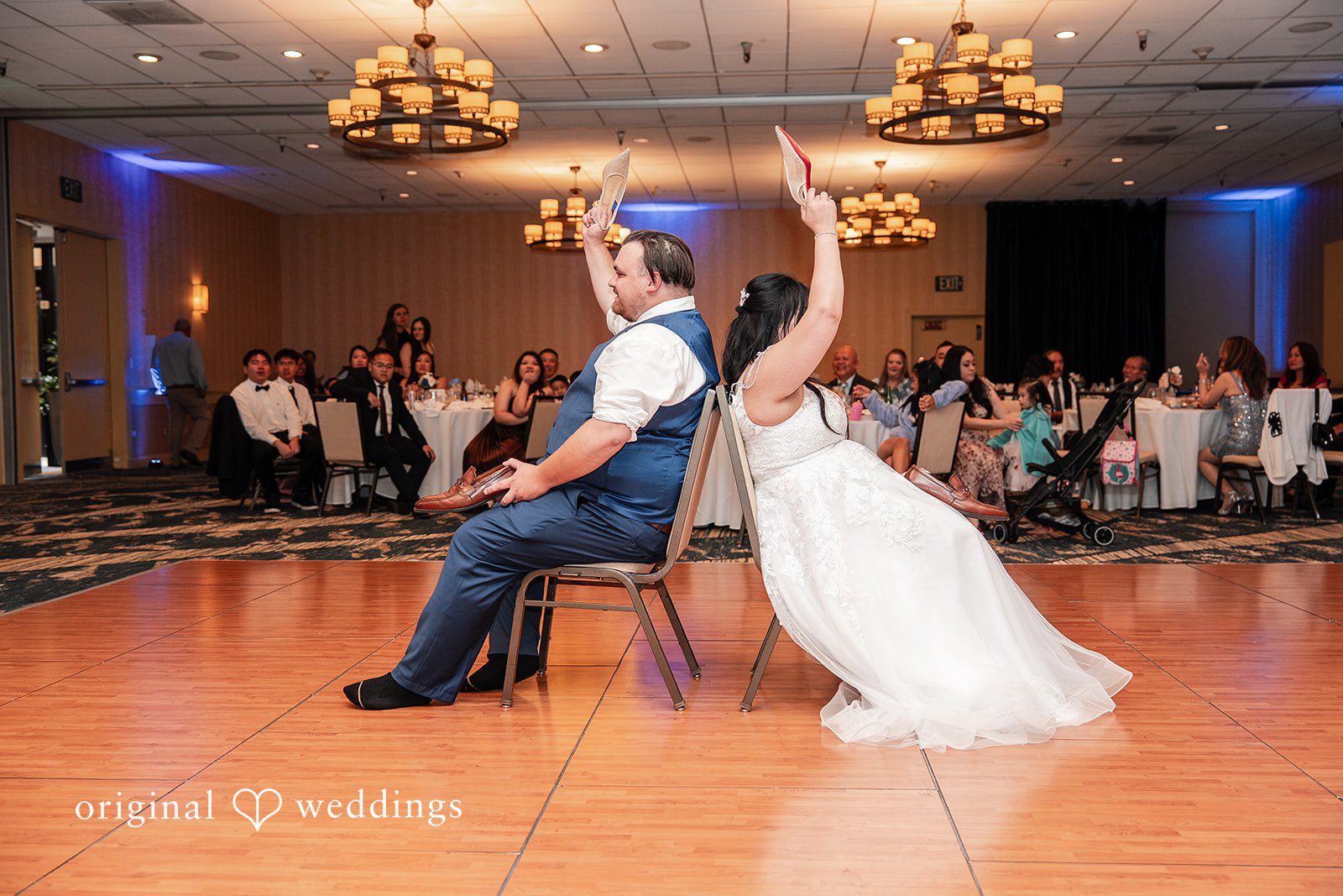 Thuy + Ryan Bride and groom playing the wedding shoe game during the reception at Double Tree by Hilton Hotel Berkeley