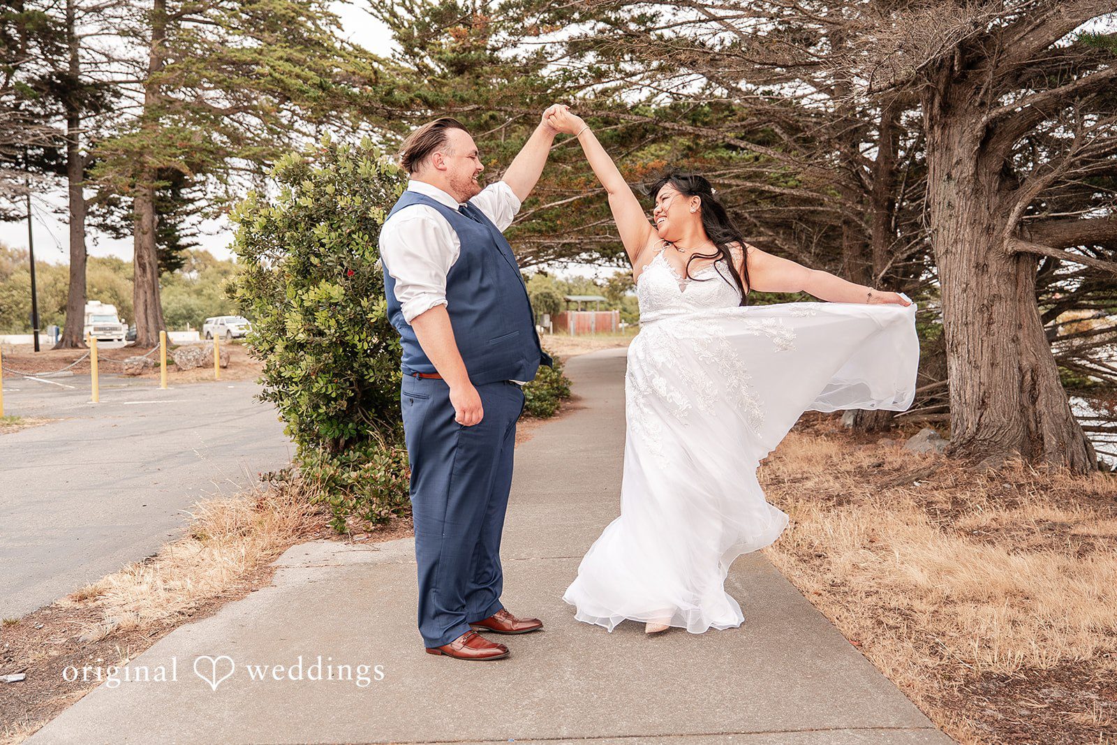 Thuy + Ryan Bride twirling while holding the groom's hand during a romantic photo session