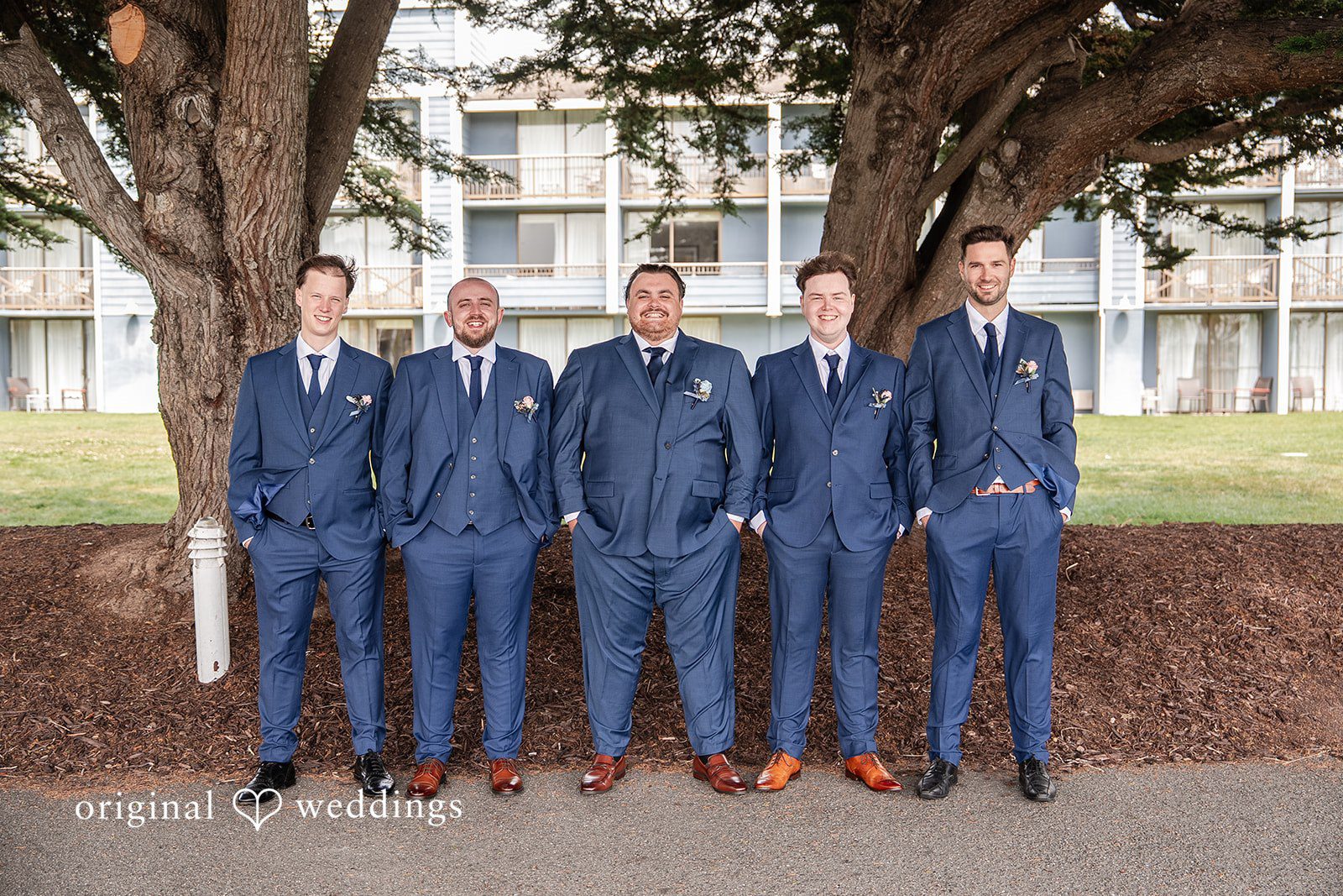 Thuy + Ryan Groom smiling with the groomsmen before the ceremony at Double Tree by Hilton Hotel Berkeley
