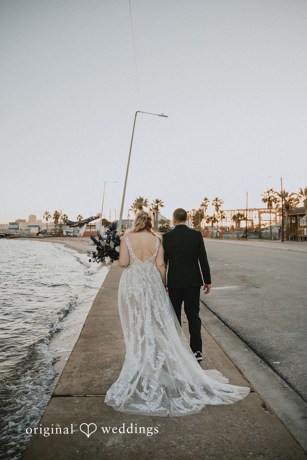 Allison + Justin Back view of the couple walking together at DoubleTree by Hilton Corpus Christi Beachfront