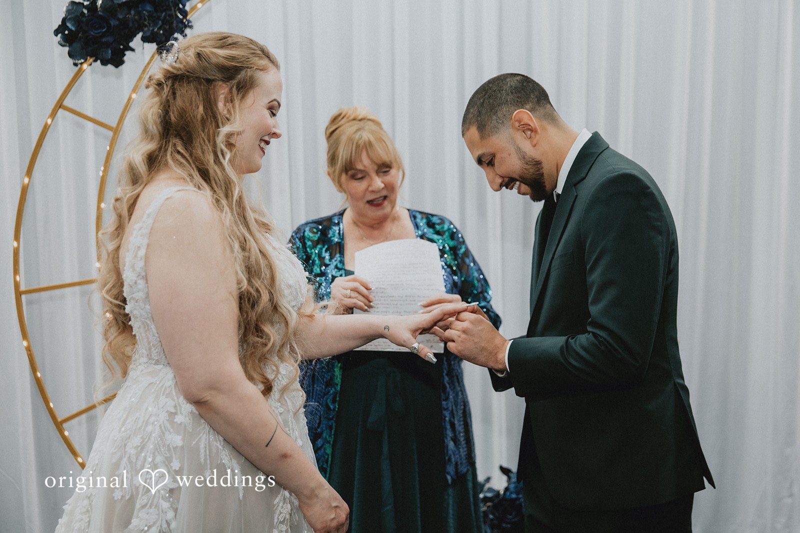 Allison + Justin Groom placing the wedding ring on the bride at DoubleTree by Hilton Corpus Christi Beachfront