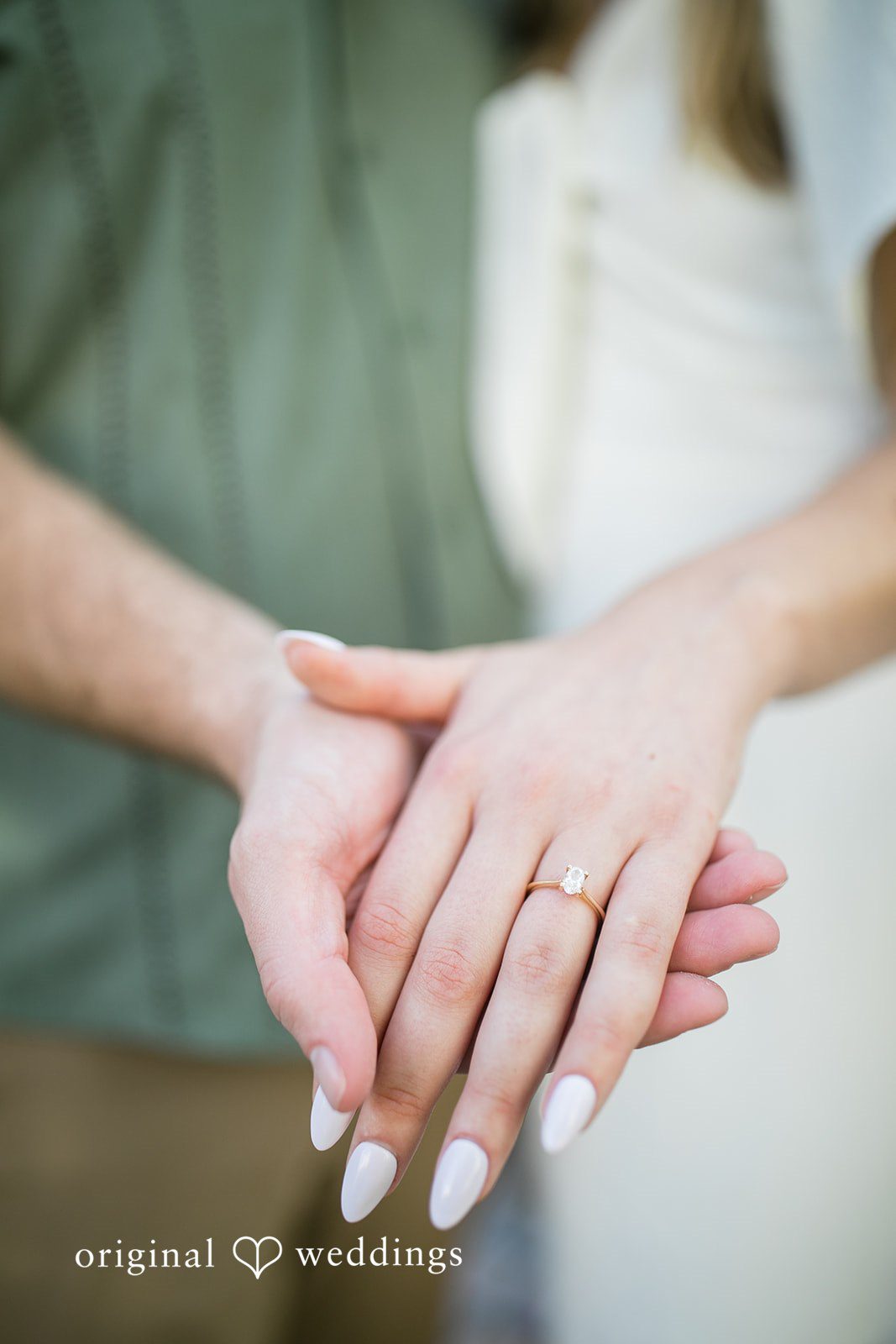 Lauren + Miles Close-up of a couple's hands displaying an engagement ring.