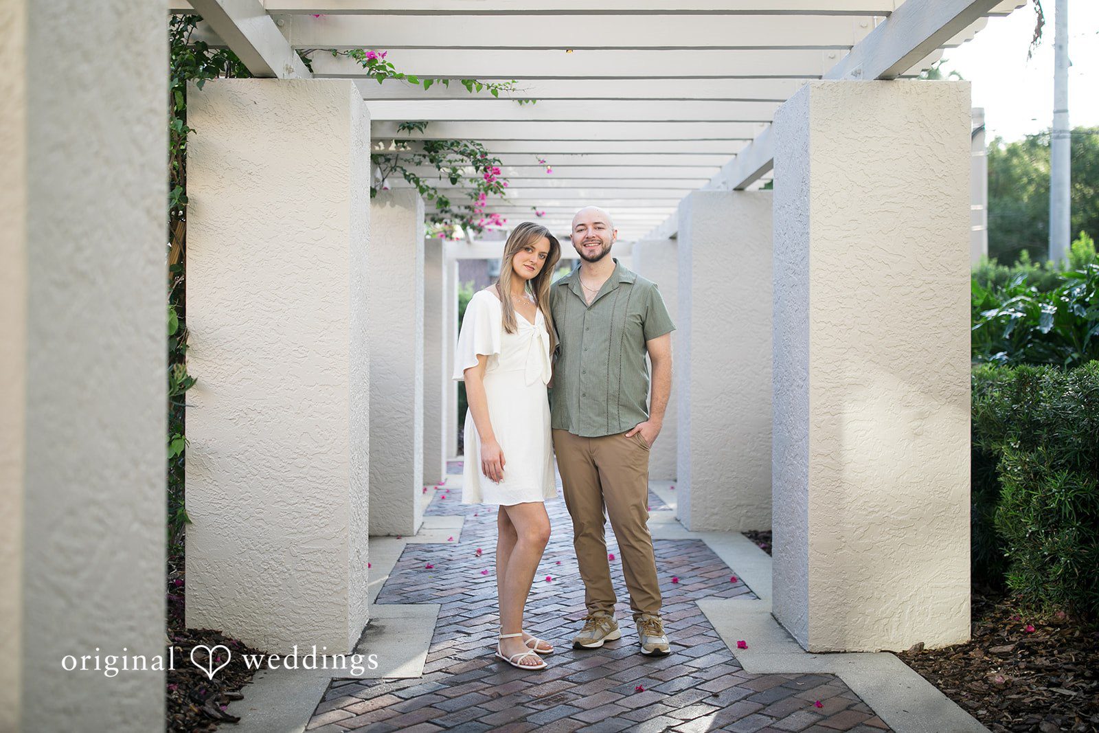 Lauren + Miles A couple standing together under a garden pergola path.
