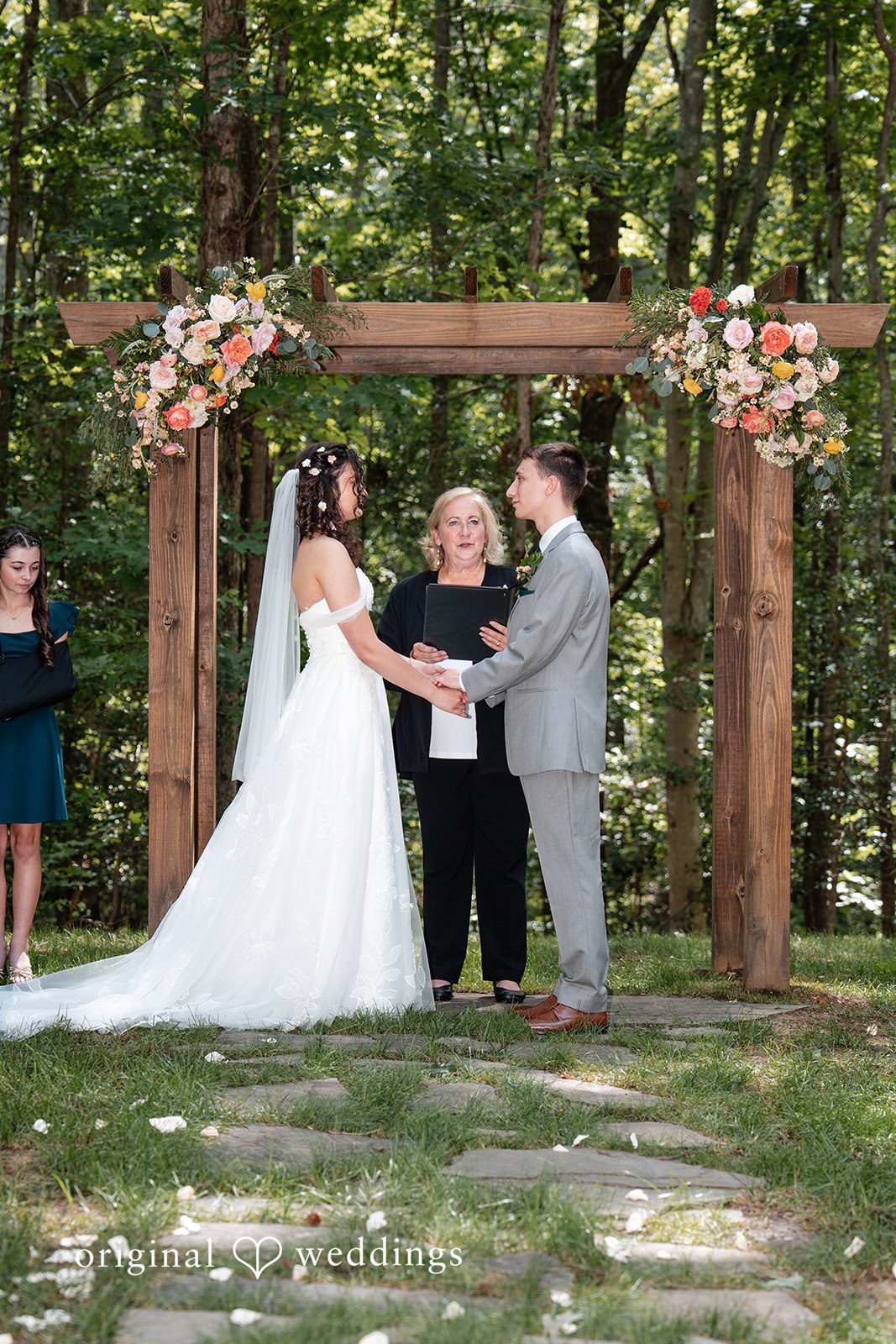 Conner + Ashley A bride and groom exchanging vows at an altar during their ceremony.
