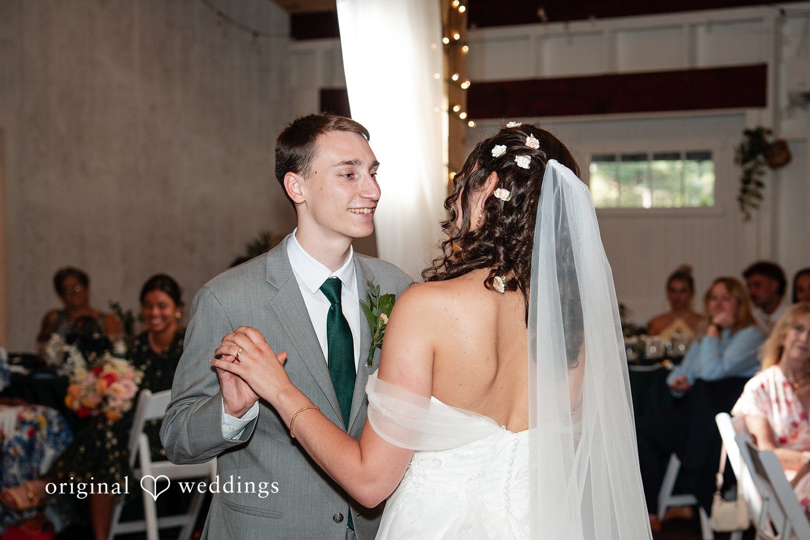 Conner + Ashley A groom smiling while dancing closely with his bride at their reception.