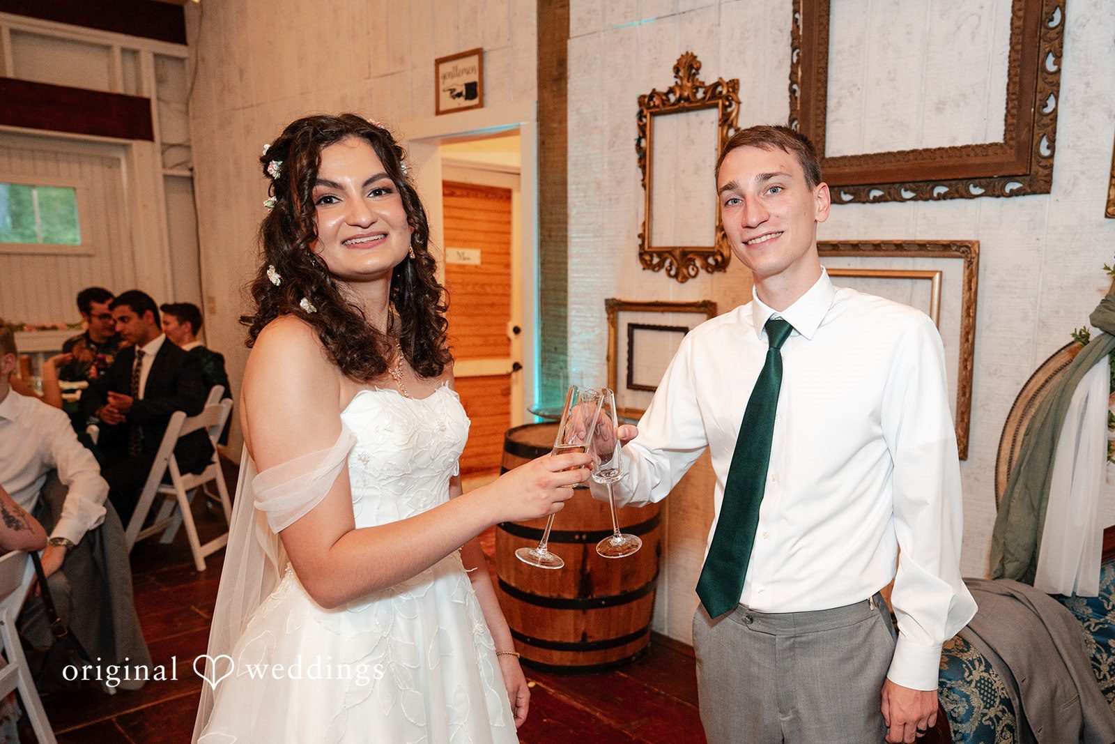 Conner + Ashley A bride and groom holding hands and smiling at each other by a bar area.