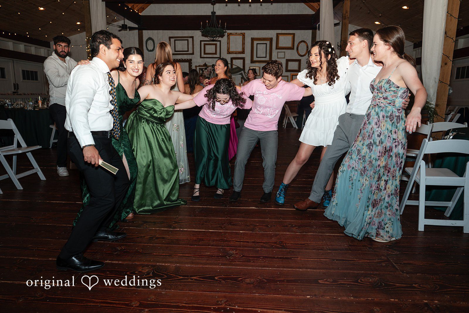 Conner + Ashley A lively group of wedding guests dancing together on the dance floor.