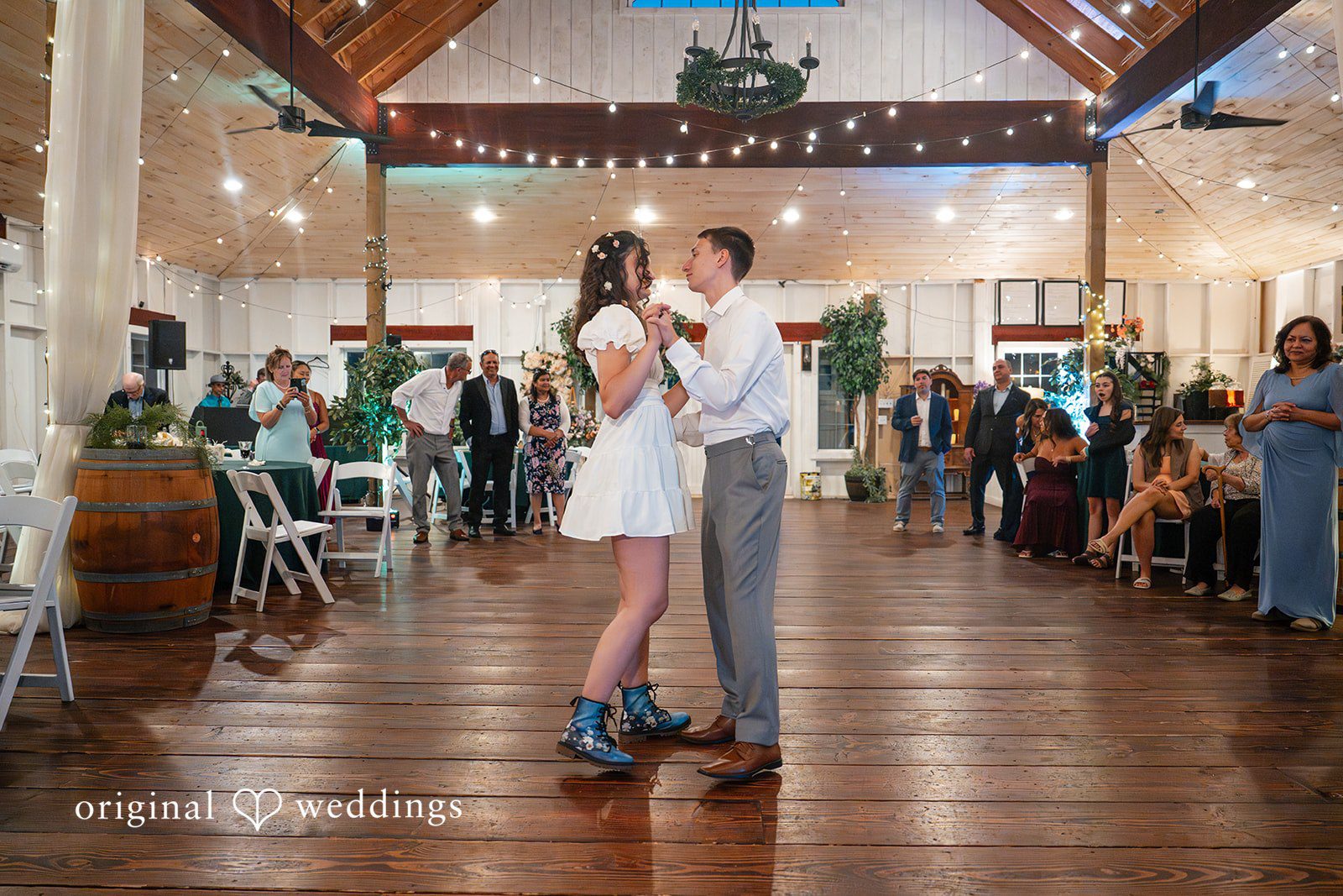 Conner + Ashley A bride and groom dancing in the center of a spacious reception hall.