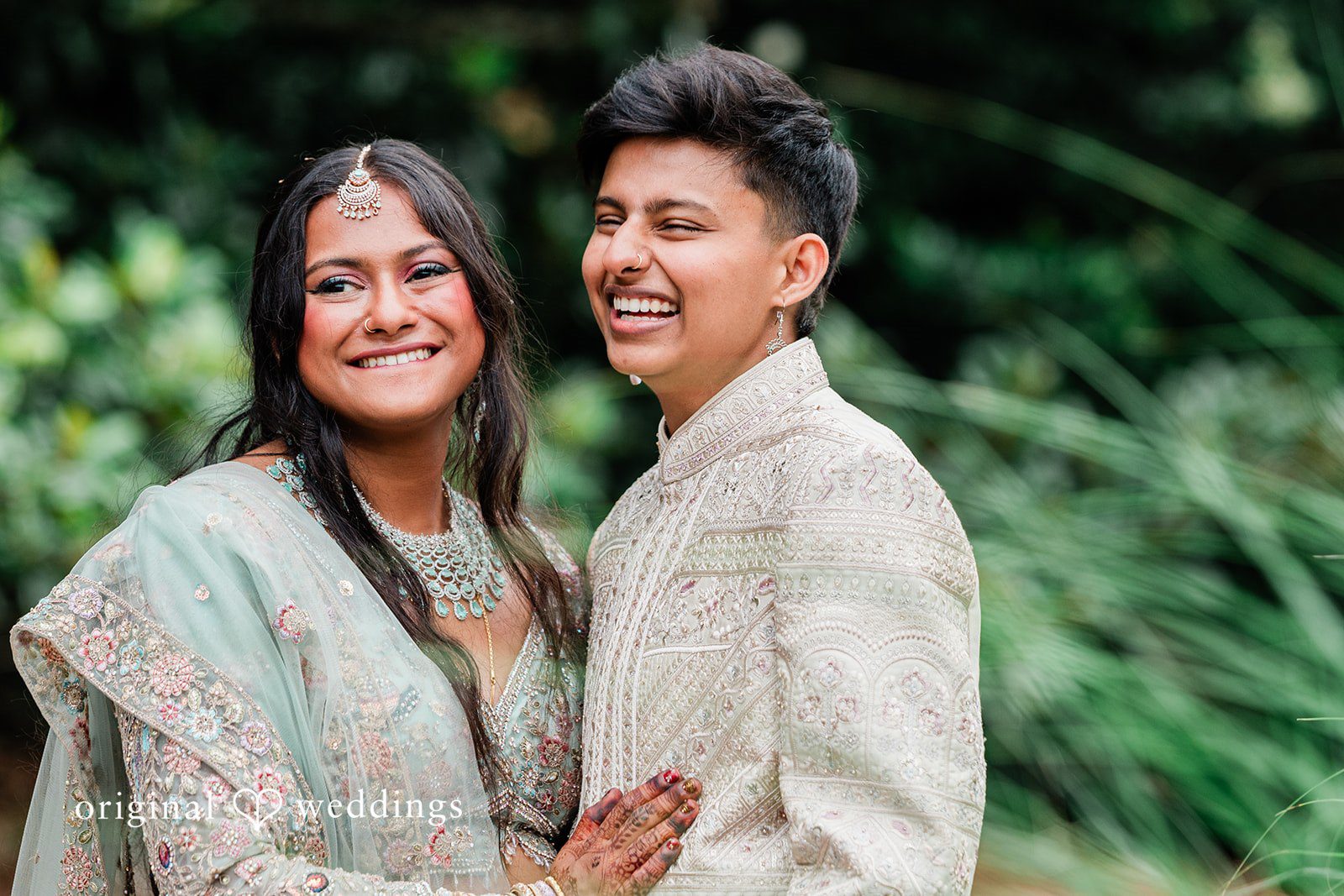 Sonya + Akshaya A joyful close-up portrait of a laughing bride and groom at Fernbank Museum.