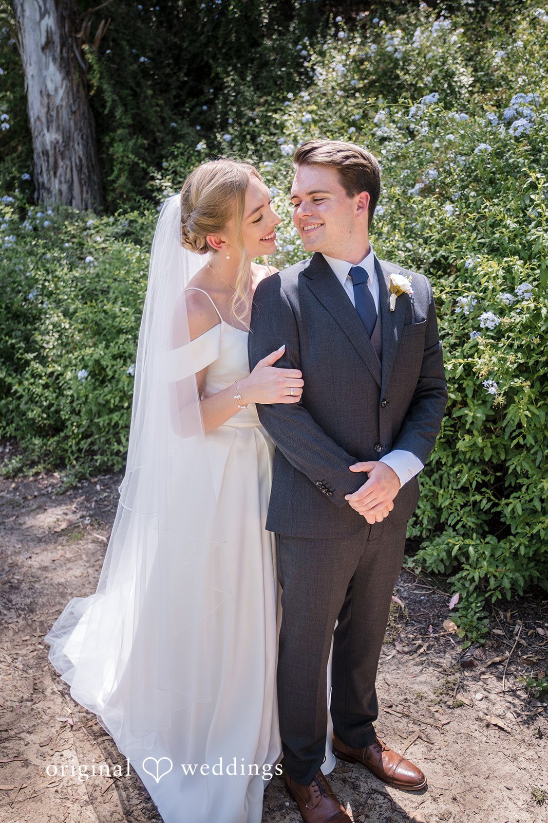 Madeline + Brady Bride and groom smiling and loonking at each other at Fullerton Community Center