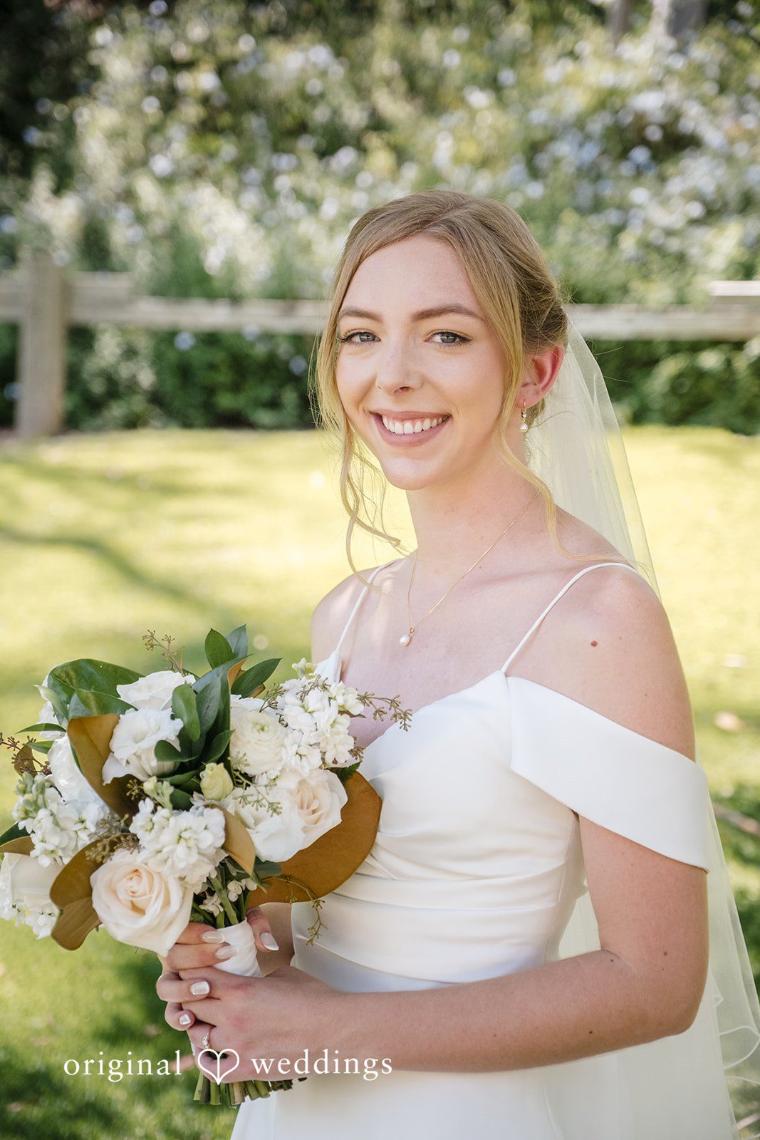 Madeline + Brady Happy bride smiling while holding a beautiful bouquet before the ceremony