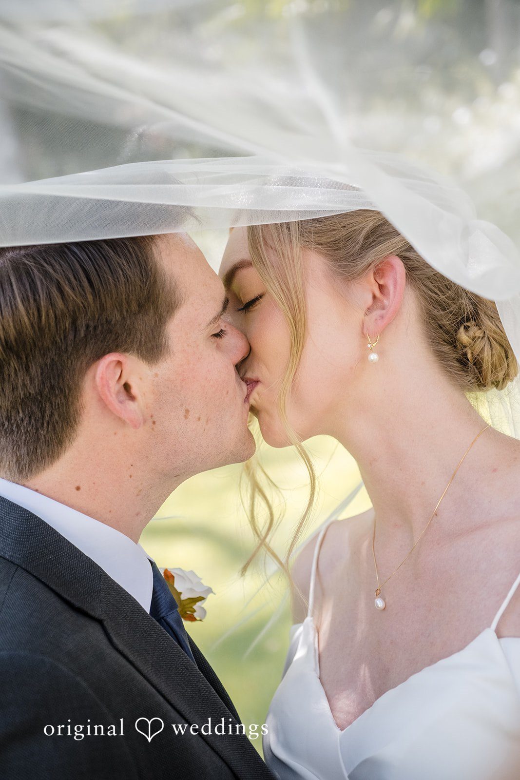 Madeline + Brady Bride and groom sharing a romantic kiss at Fullerton Community Center