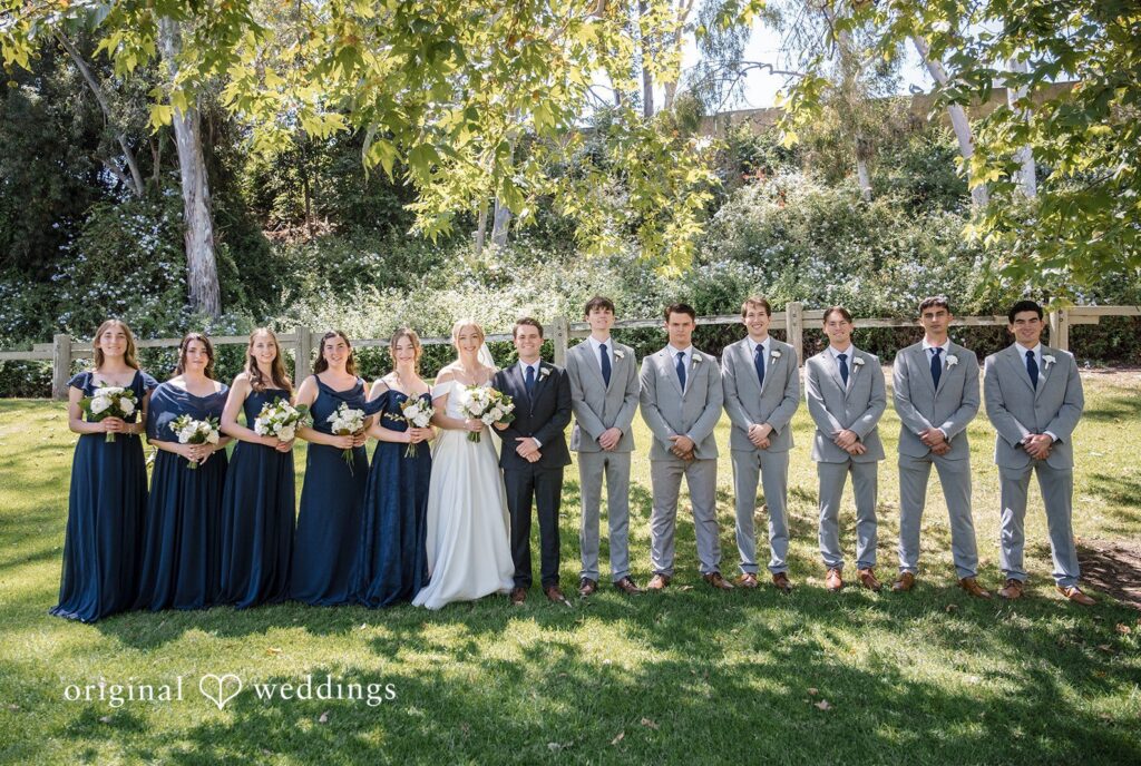 Madeline + Brady Bride and groom celebrating with bridesmaids and groomsmen after the ceremony at Fullerton Community Center capturing the full bridal party by Original Weddings.