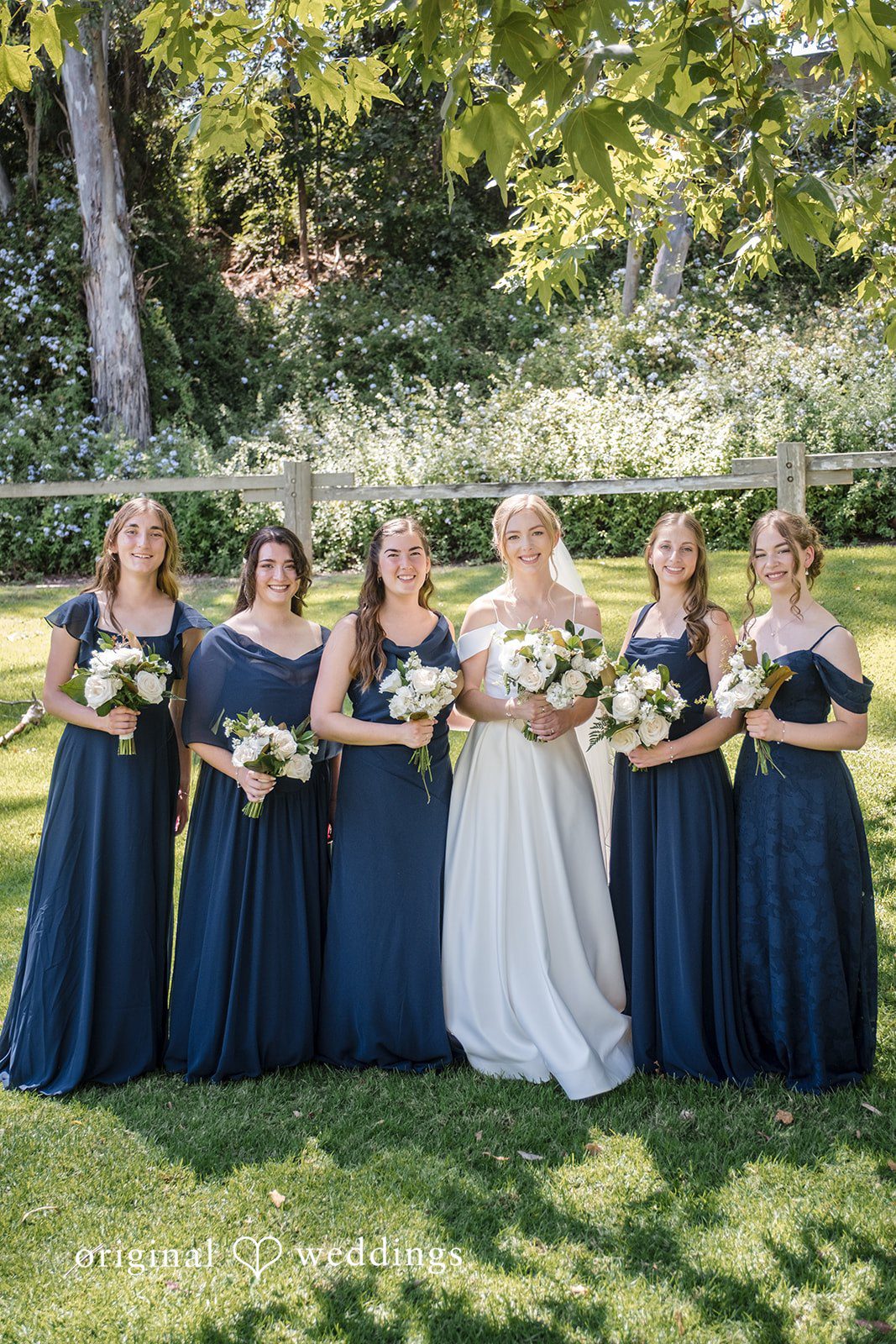 Madeline + Brady Bride posing with her bridesmaids while sharing joyful moments before the ceremony