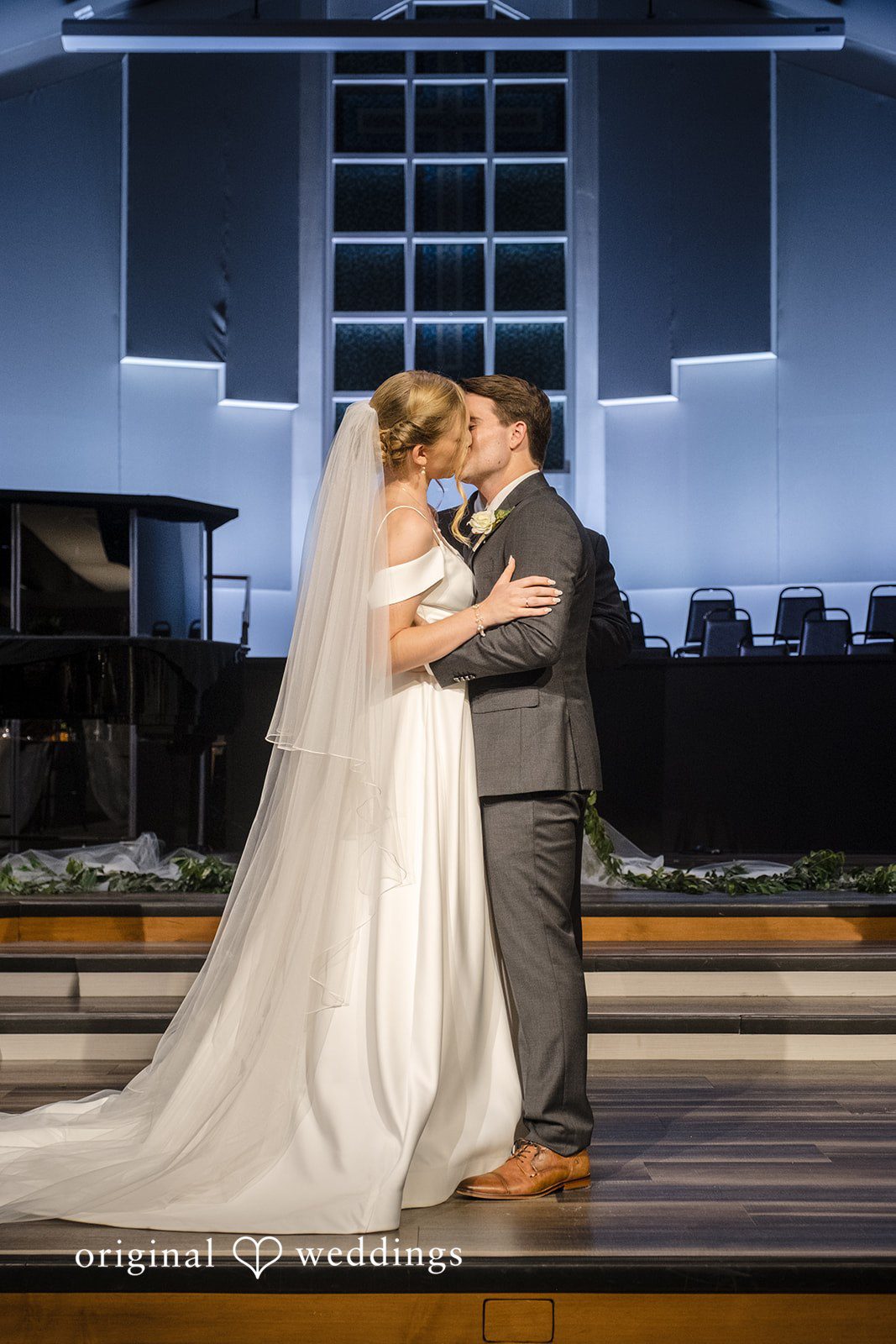Madeline + Brady Couple sharing a romantic kiss at Fullerton Community Center
