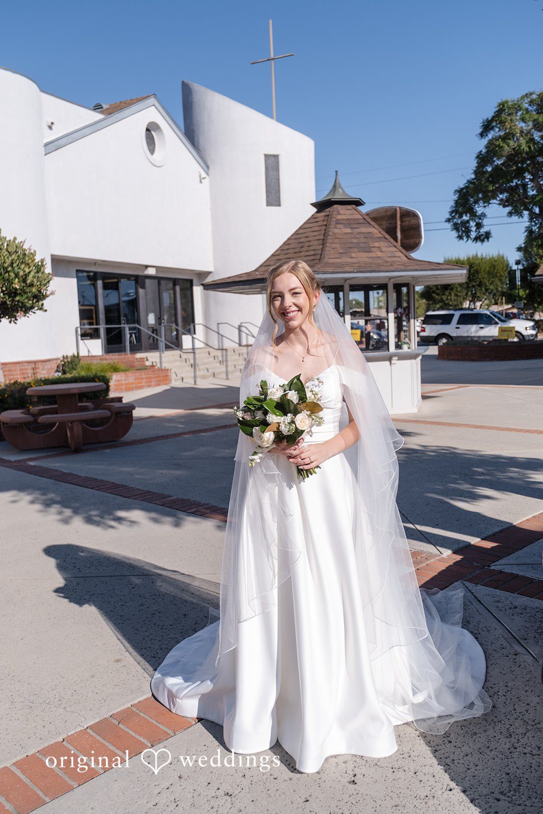 Madeline + Brady Bride posing with her bouquet at Fullerton Community Center