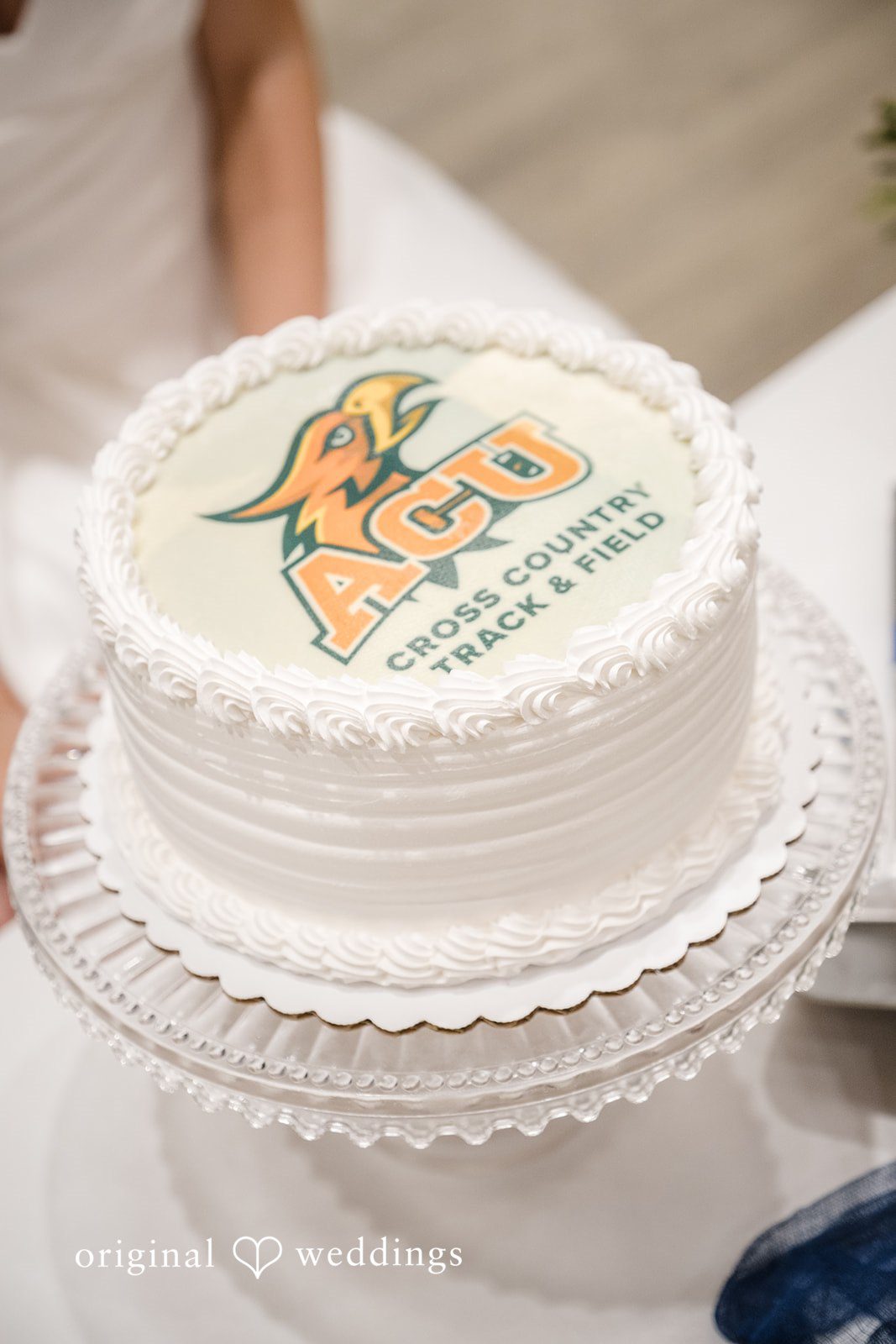 Madeline + Brady Close-up of an elegant white wedding cake featuring a personalised design for the celebration