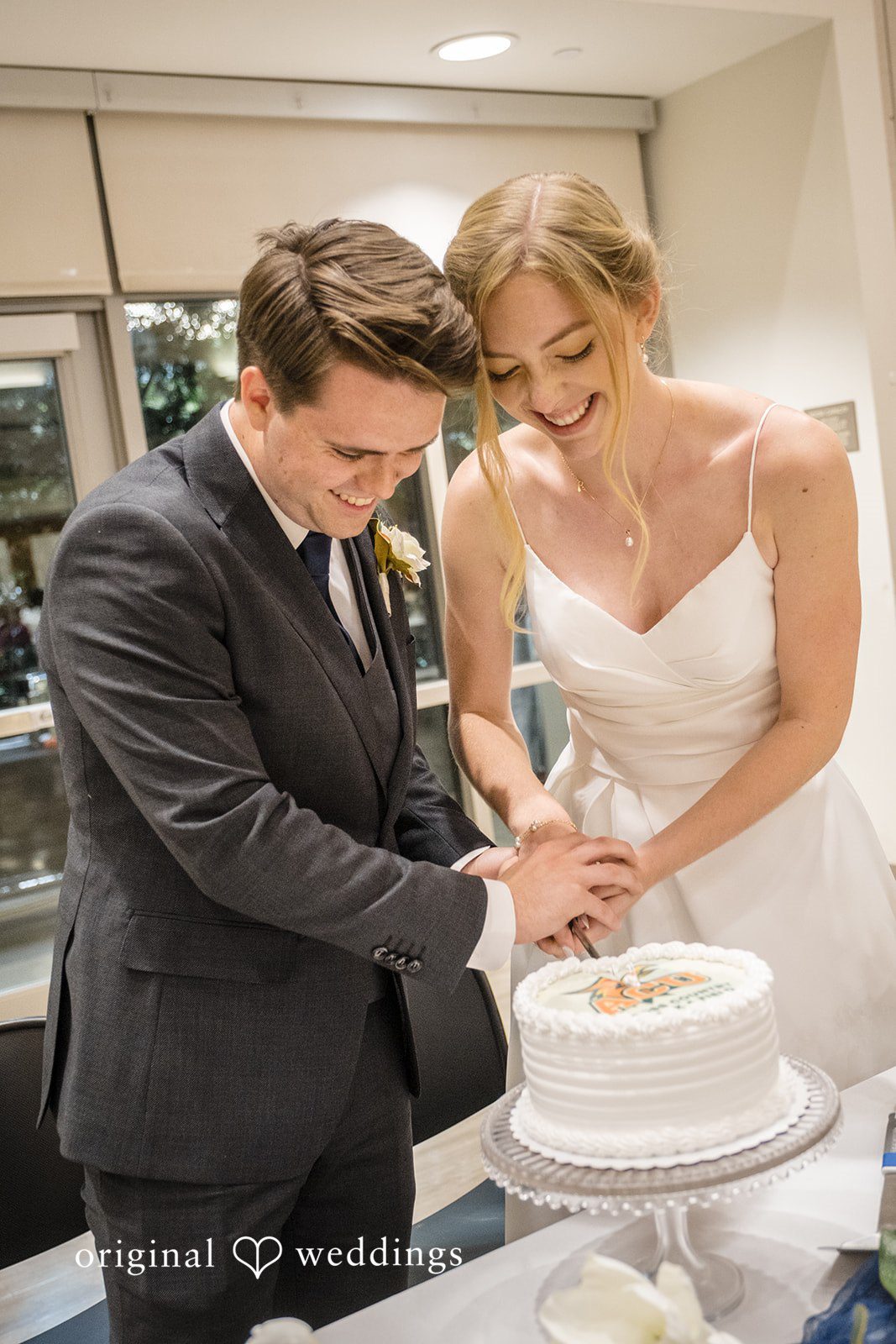Madeline + Brady Bride and groom cutting their wedding cake at Fullerton Community Center captured by Los Angeles Wedding Photographers from Original Weddings.