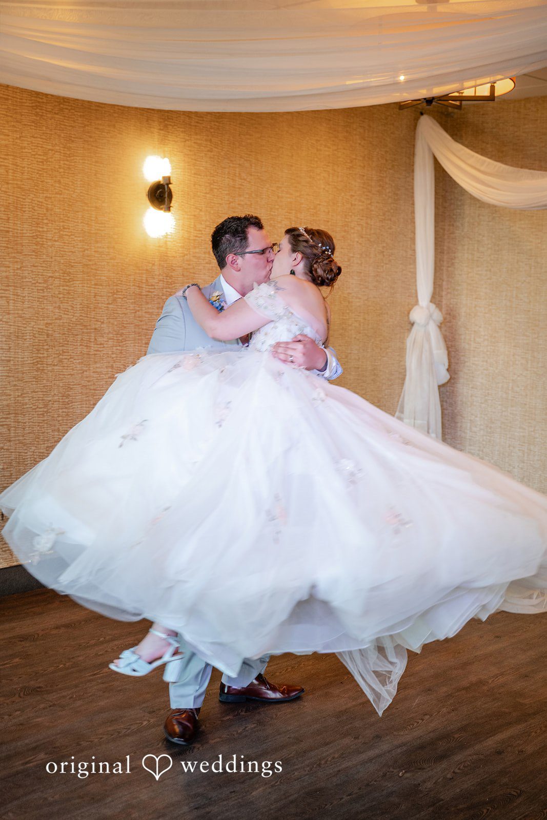 Nina + Steven Groom lifting up the bride while sharing a sweet kiss
