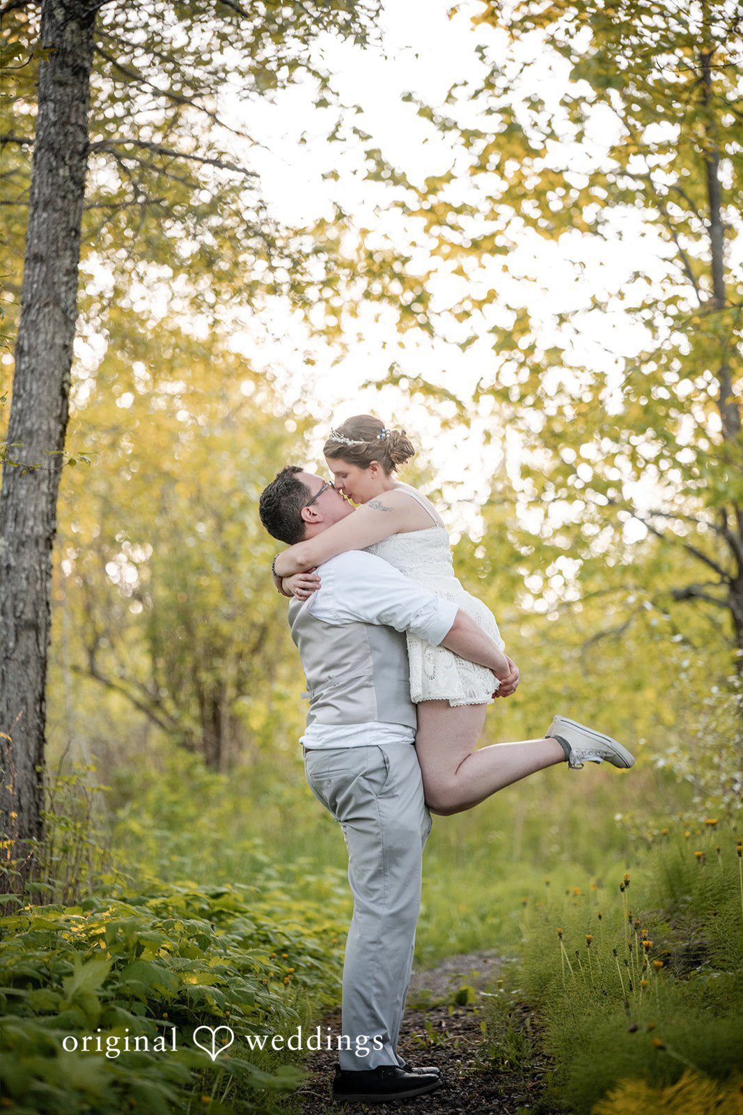 Nina + Steven Groom lifting up the bride at Grand Superior Lodge
