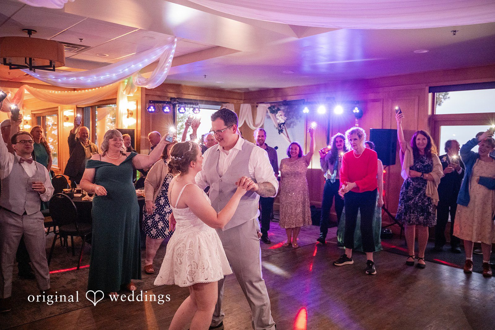 Nina + Steven Bride and groom sharing a dance while guests cheering around