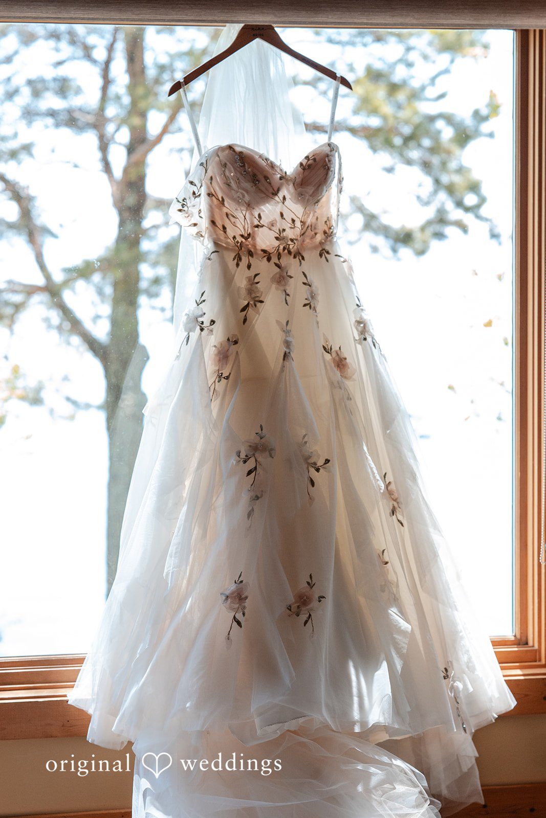 Nina + Steven Detailed picture of bridal wedding gown hanged across the window at Grand Superior Lodge