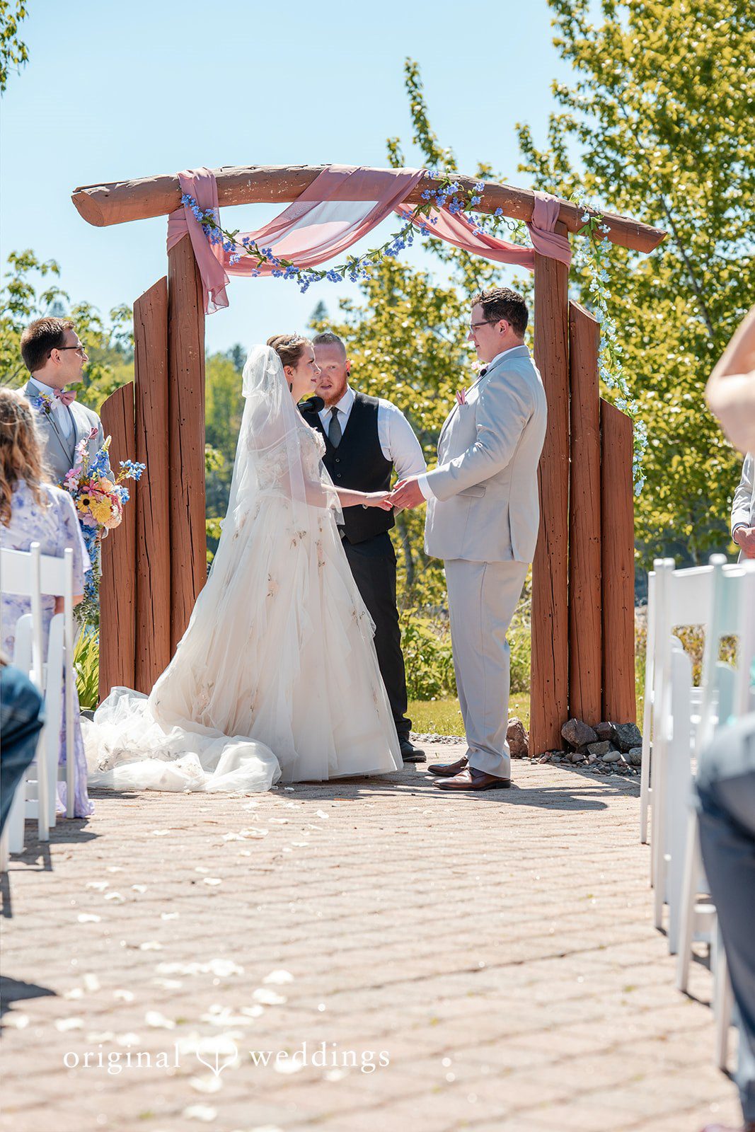 Nina + Steven Couple exchanging vows during elegant wedding ceremony at Grand Superior Lodge