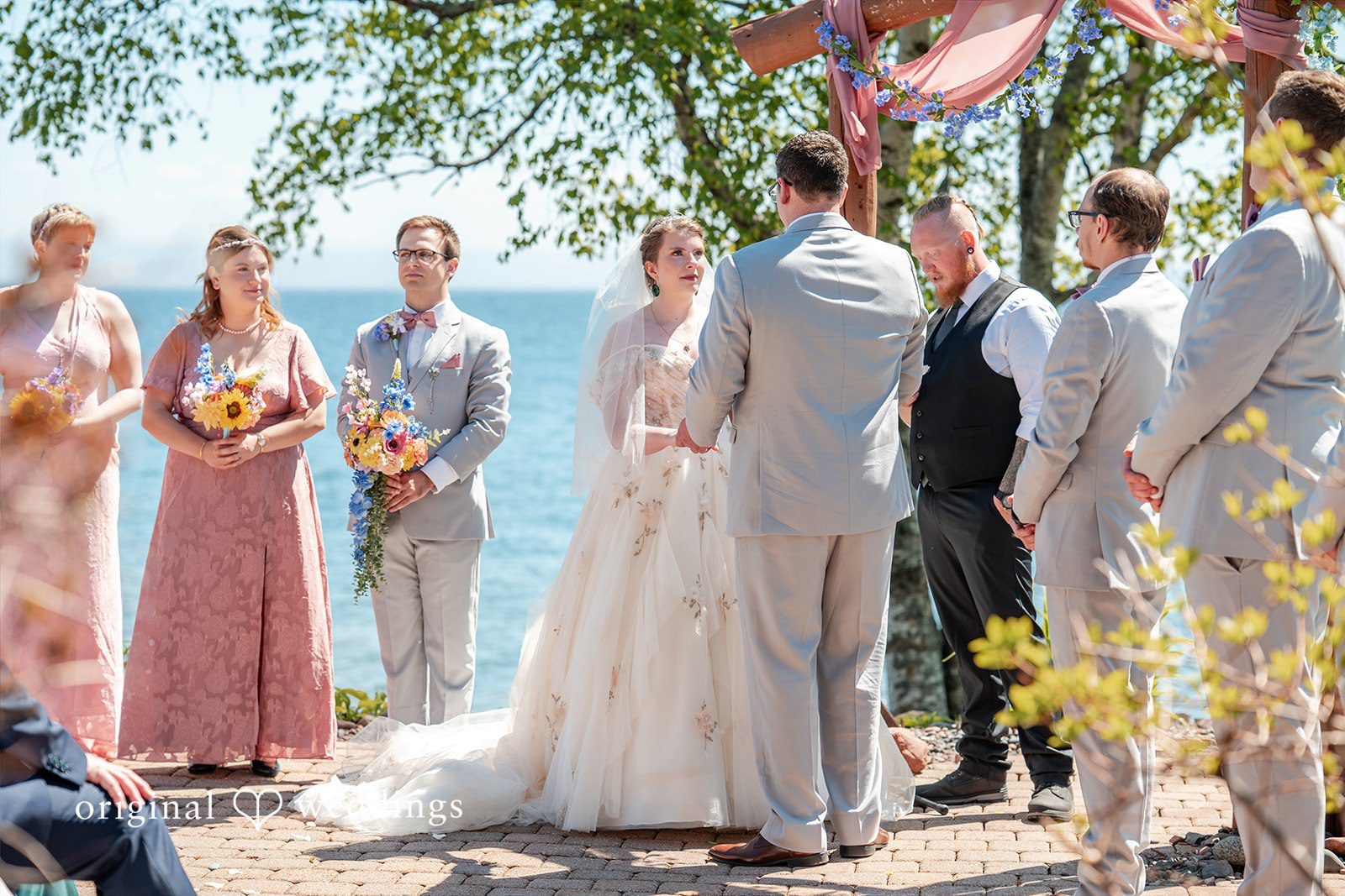 Nina + Steven Couple exchanging vows during elegant wedding ceremony at Grand Superior Lodge