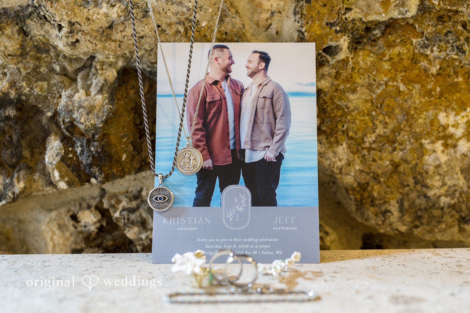 Kristian + Jeff A framed portrait of two men displayed on a rustic tabletop against a stone wall.