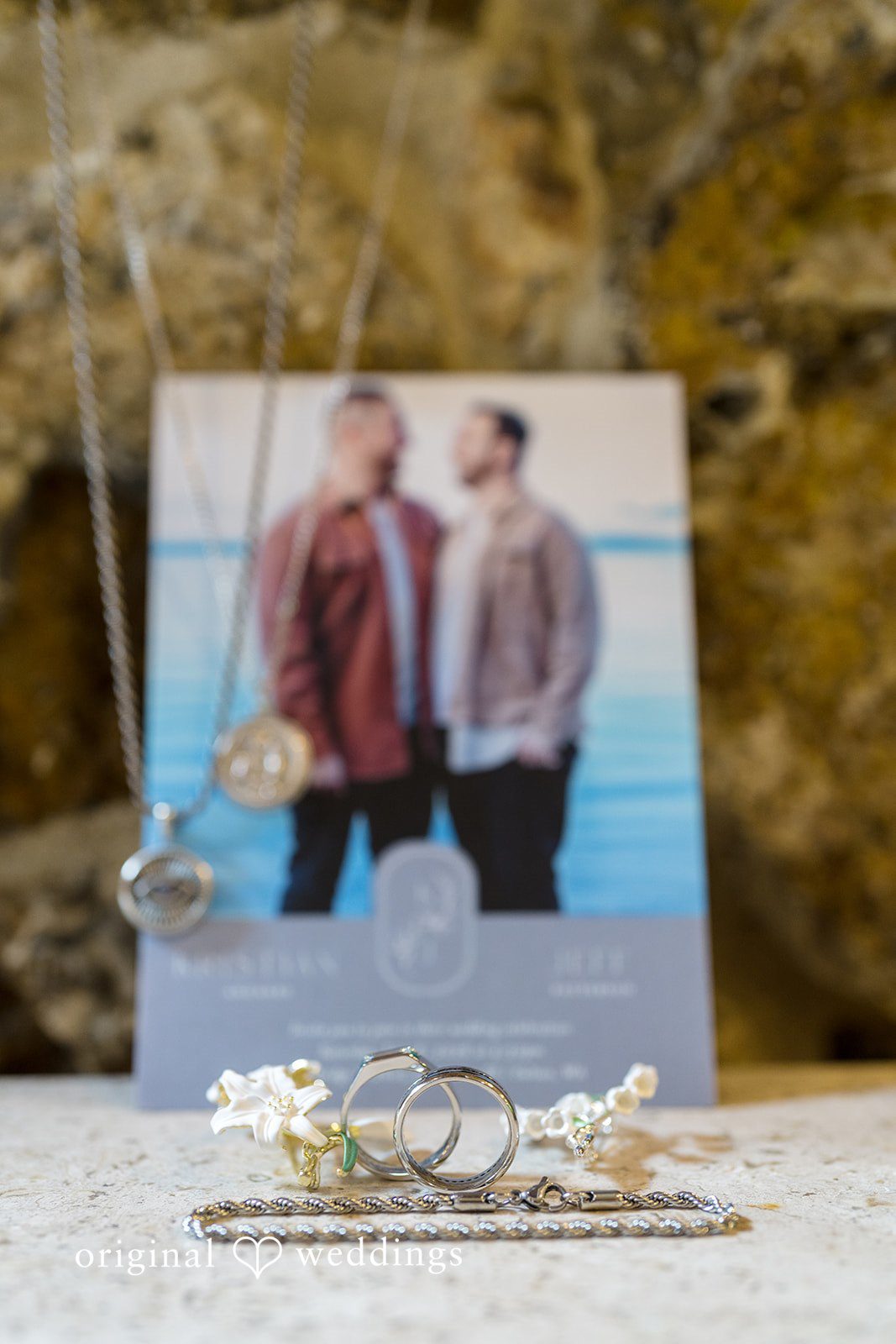 Kristian + Jeff A framed picture of a couple sitting on a decorated table with small decorative accents in front.