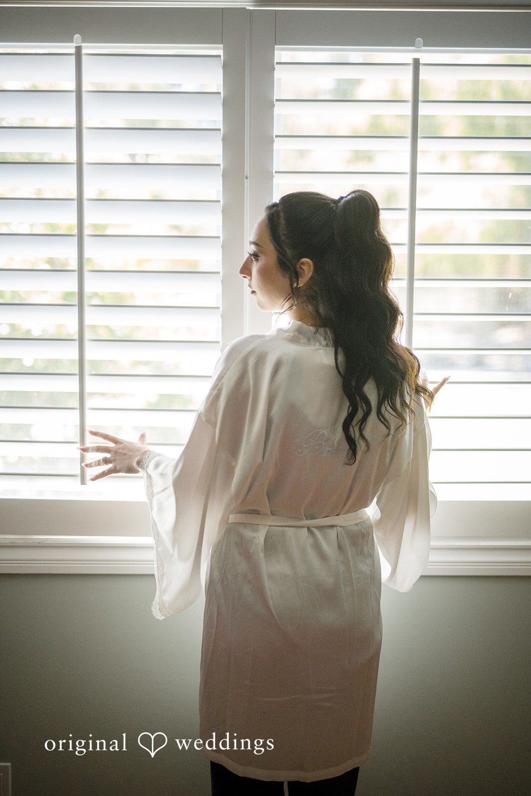 Janelle + Yaser Bride looking at the window at Green Hills Country Club