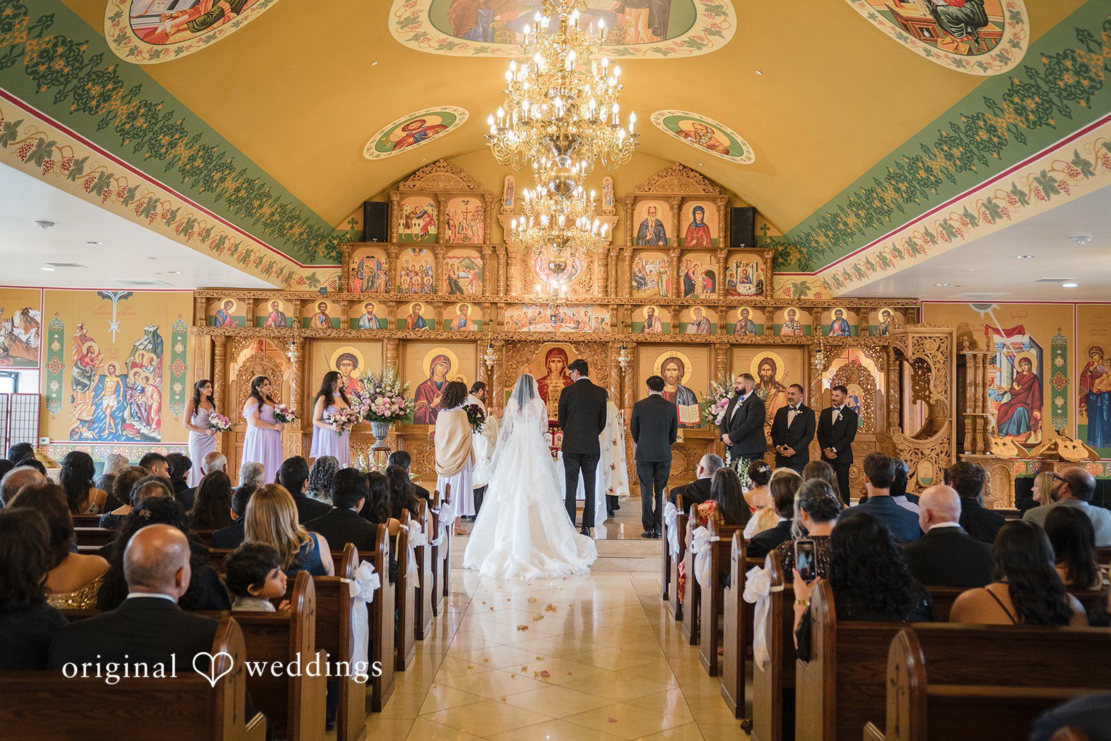 Janelle + Yaser Bride and groom listening to the priest during their wedding celebration