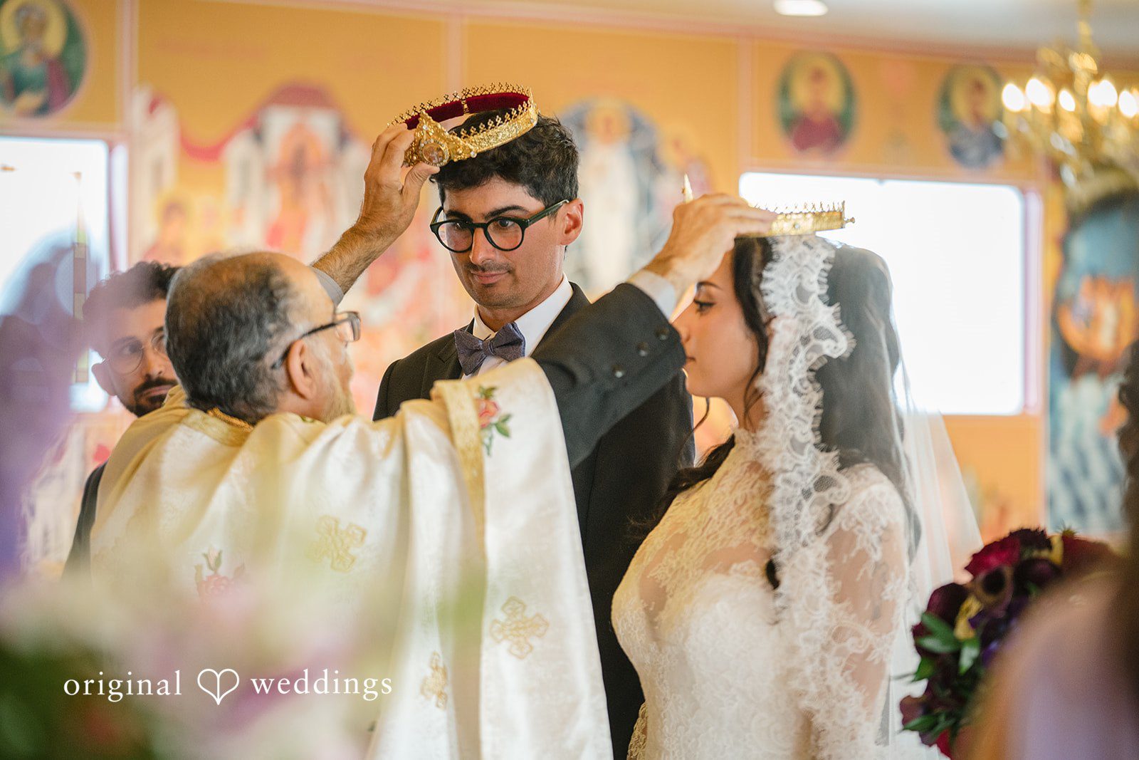 Janelle + Yaser Priest wearing the crown to the groom and bride during ceremony