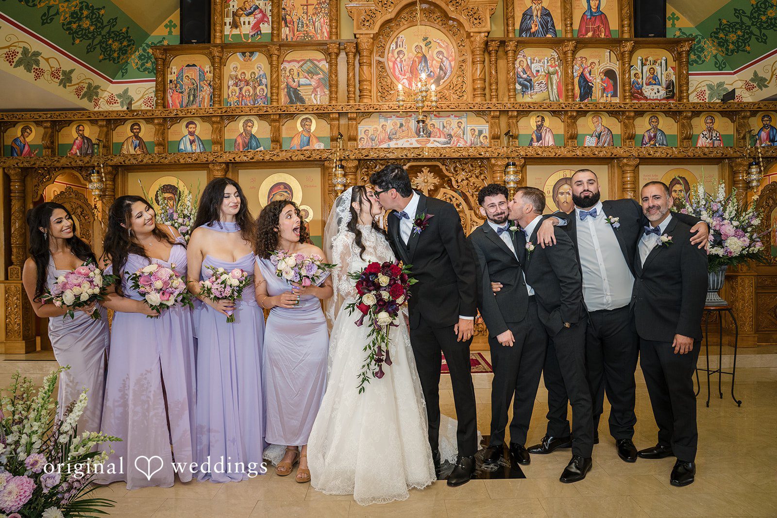 Janelle + Yaser Group photo of couple with bridesmaids and groomsmen cheering around