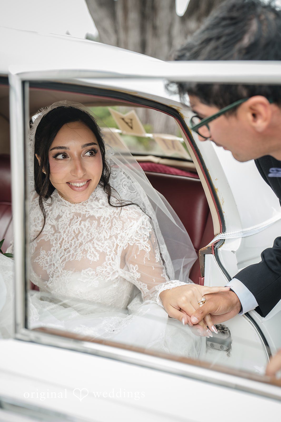 Janelle + Yaser Beautiful picture of bride sitting inside the car