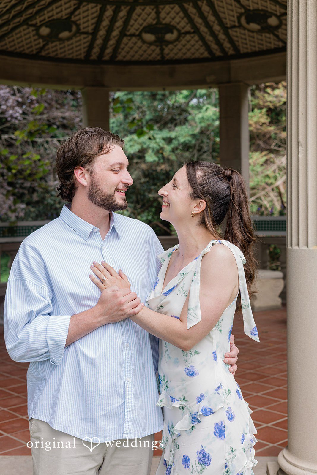 Couple looking at each other and smiling at Harkness Park