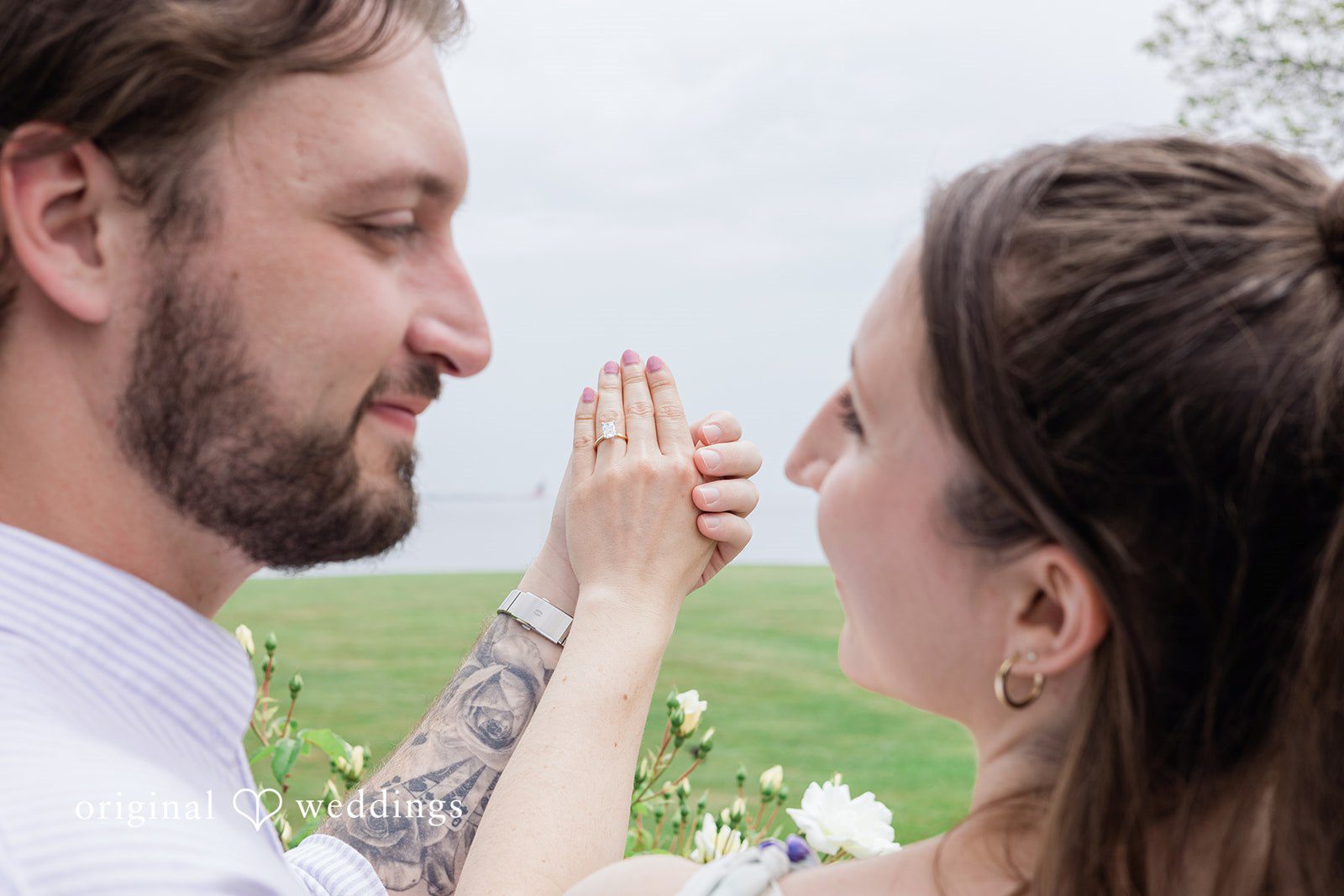 Couple looking at each other with their hands raised at Harkness Park