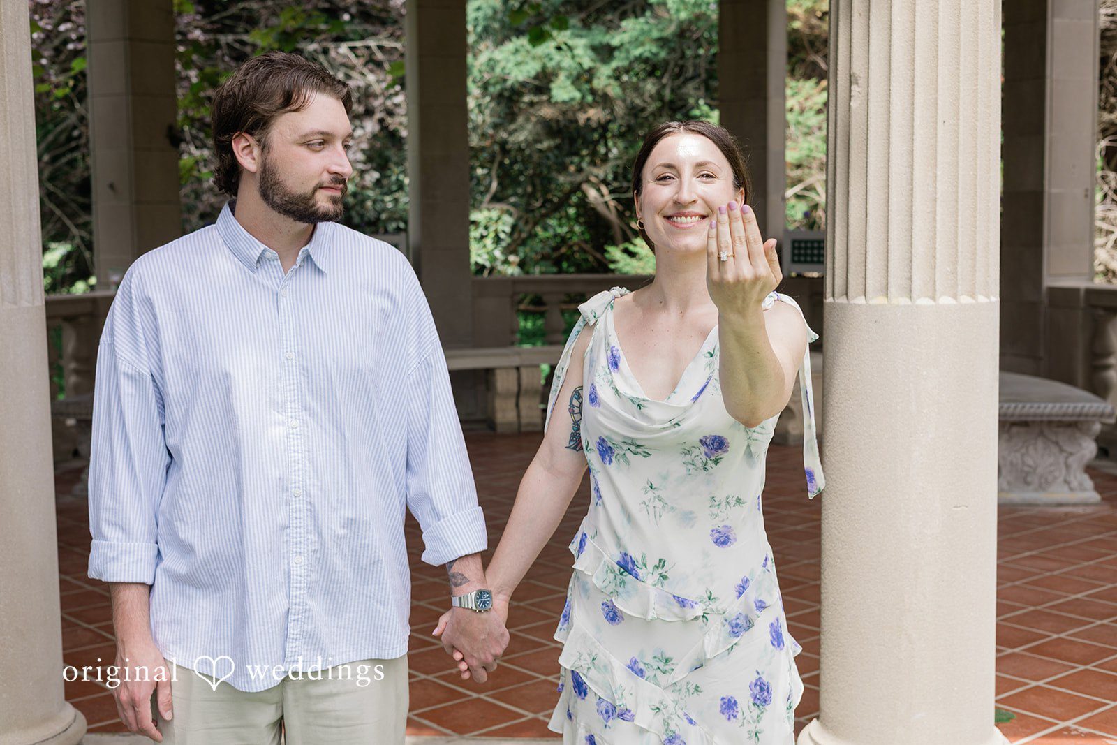 Couple standing together as the bride shows the engagement ring at Harkness Park