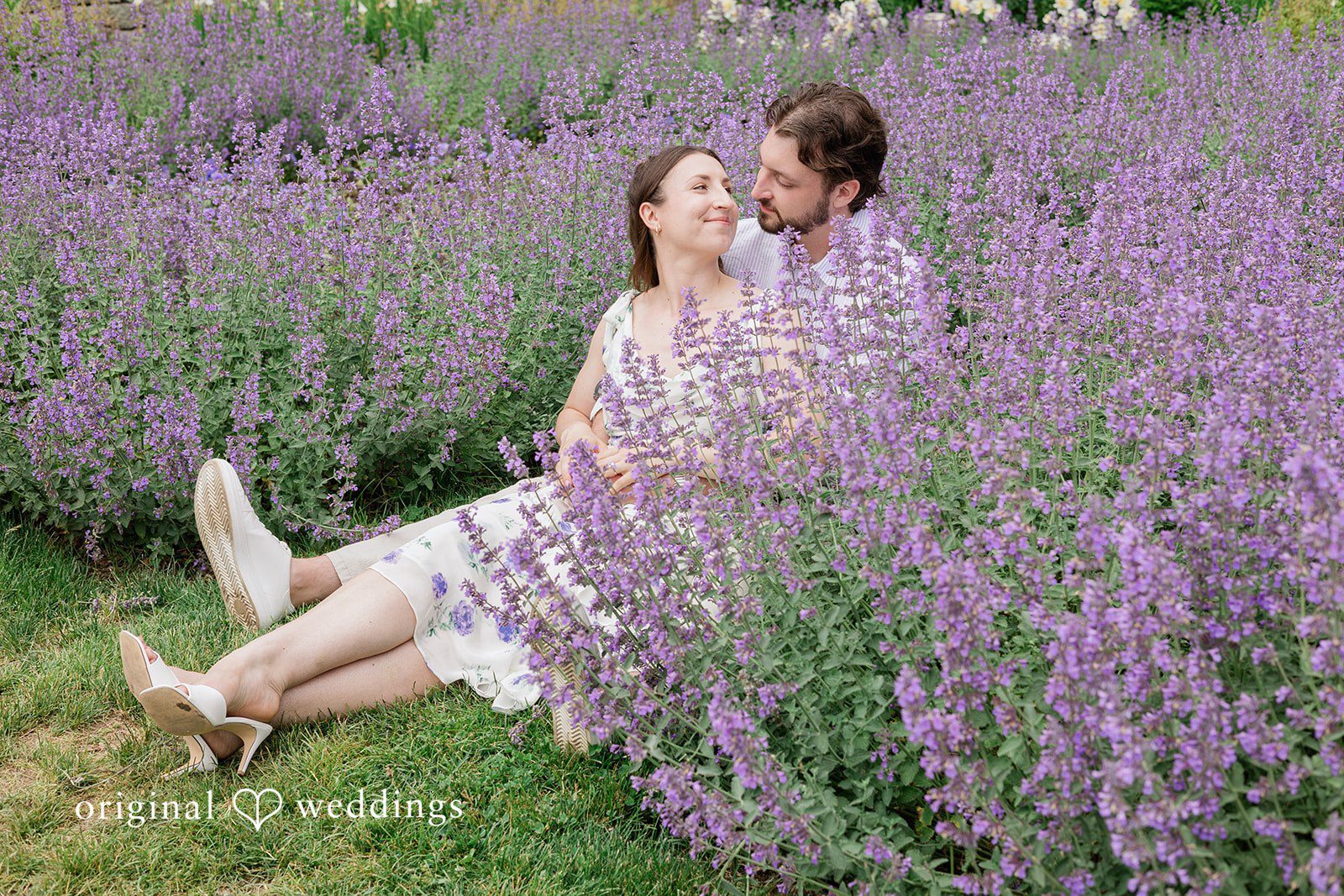 Couple sitting among the flowers in a romantic pose at Harkness Park