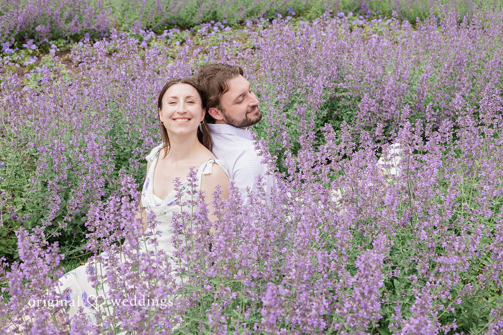 CT Engagement Photographers capturing couple sitting among the flowers in opposite directions at Harkness Park by Original Weddings