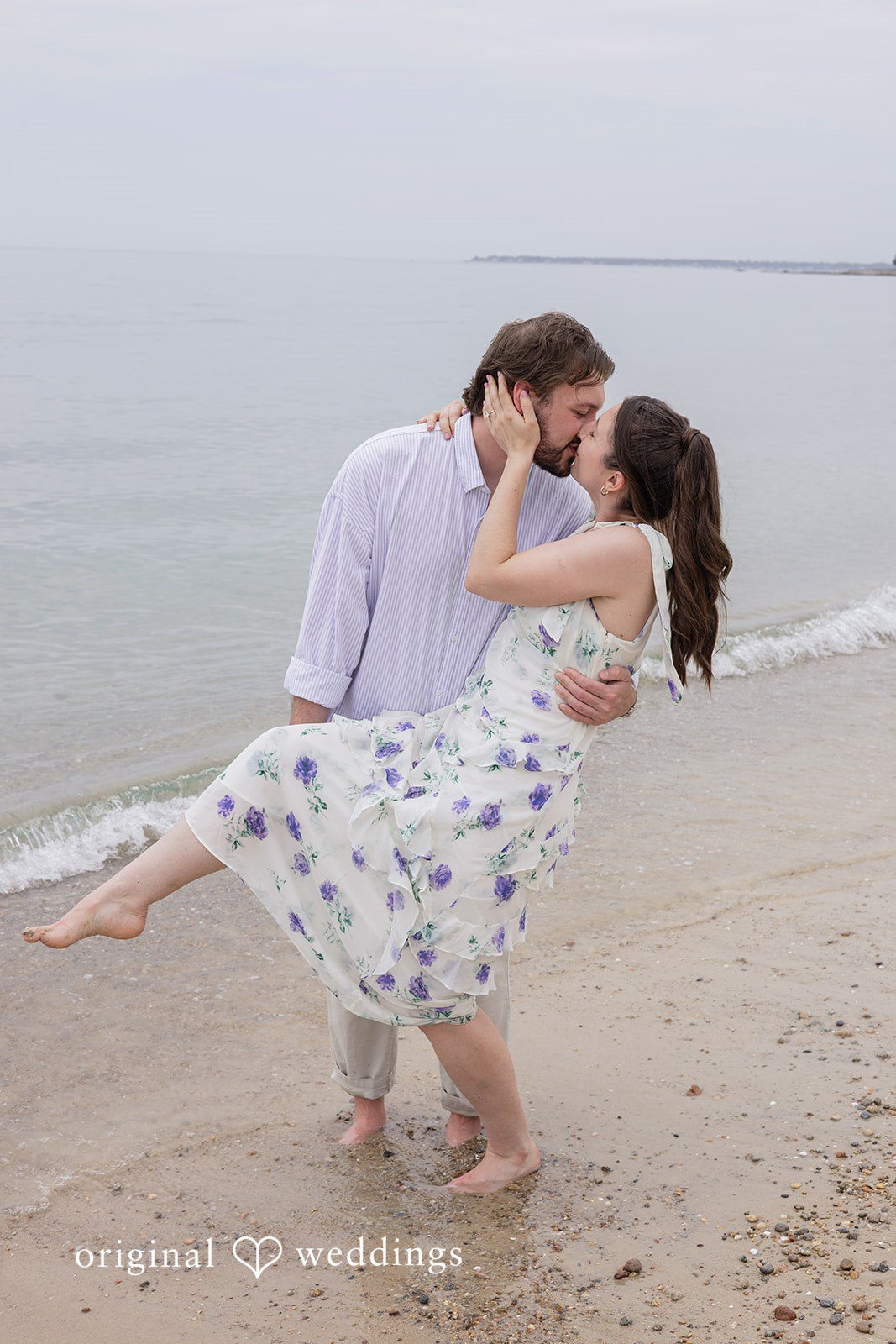 Bride and groom kissing by the waterfront at Harkness Park