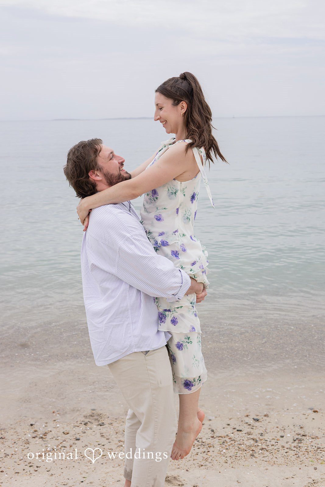 Bride smiling as the groom lifts her at Harkness Park