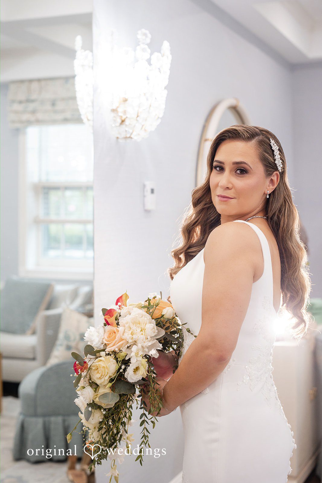 Bride holding her bouquet and looking over her shoulder.