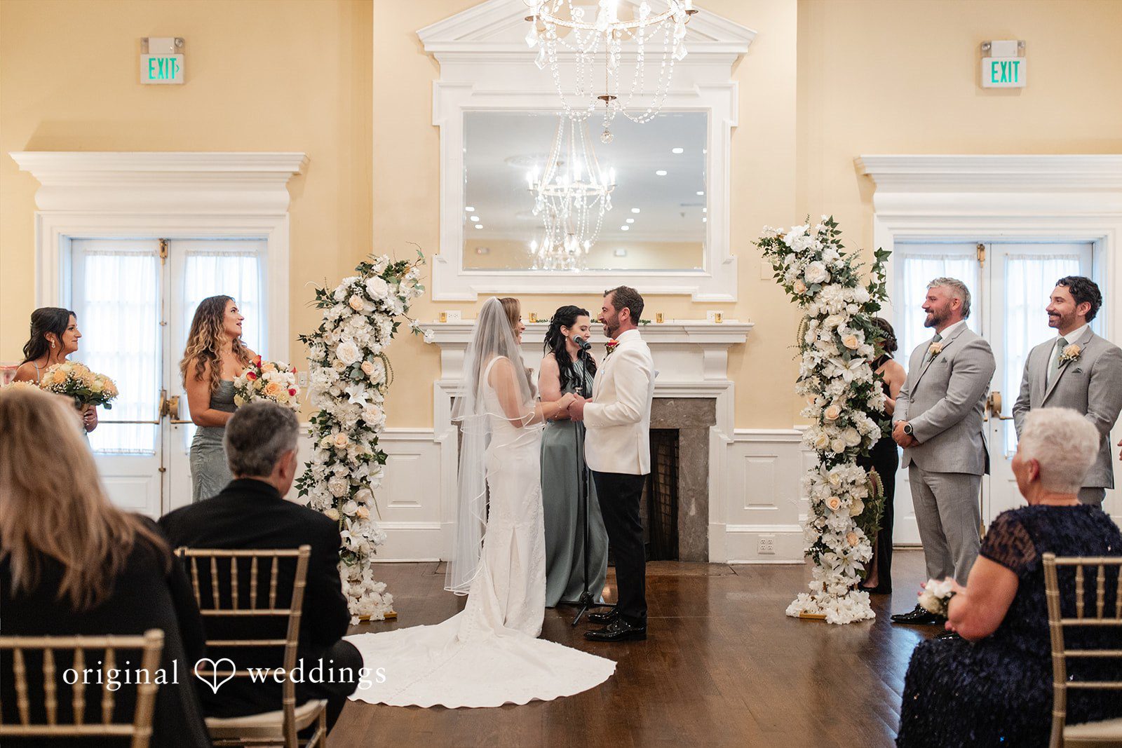 Wide shot of a wedding ceremony taking place in front of a wedding guests.