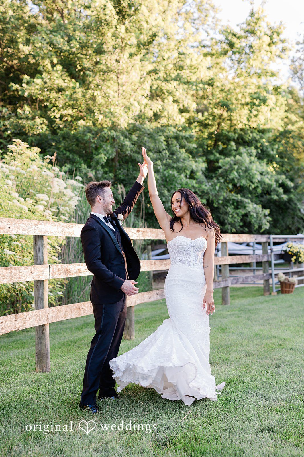 Couple looking at each other with their hands raised at Chicago Backyard